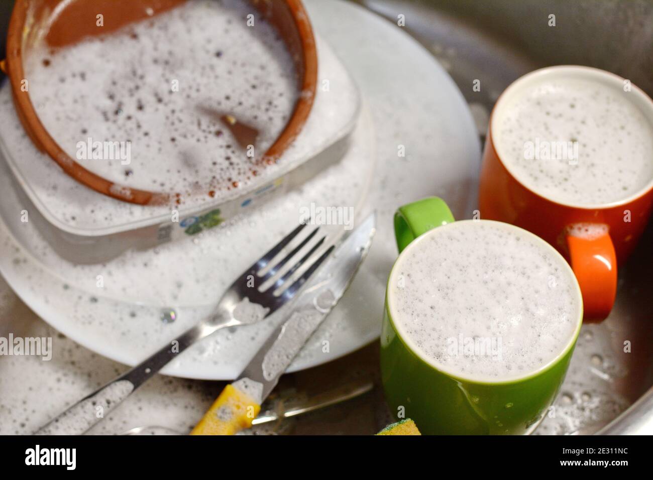 Dish washing. soaking in the kitchen sink. After the Dinner it's time
