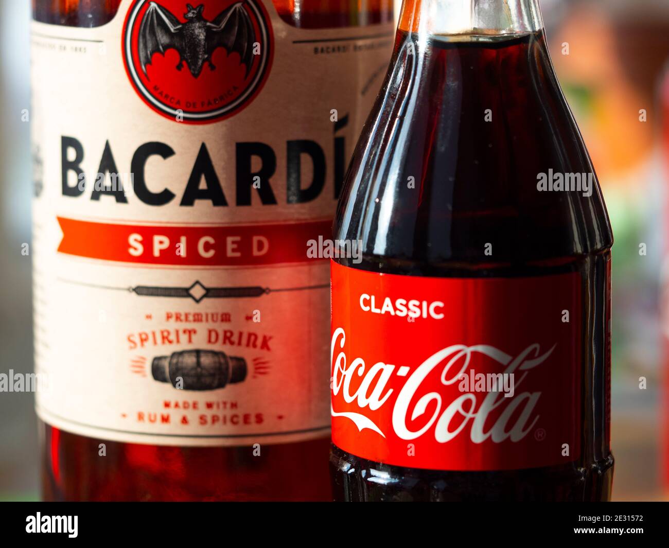 In this photo illustration seen glass bottle of Coca-Cola and Bacardi spiced rum Stock Photo