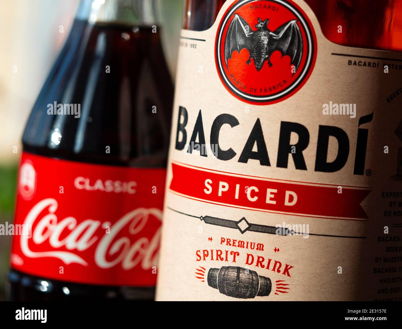 In this photo illustration seen glass bottle of Coca-Cola and Bacardi spiced rum Stock Photo
