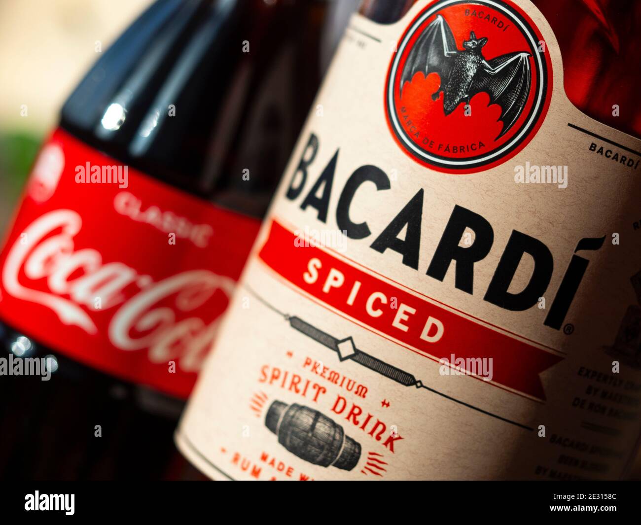 In this photo illustration seen glass bottle of Coca-Cola and Bacardi spiced rum Stock Photo