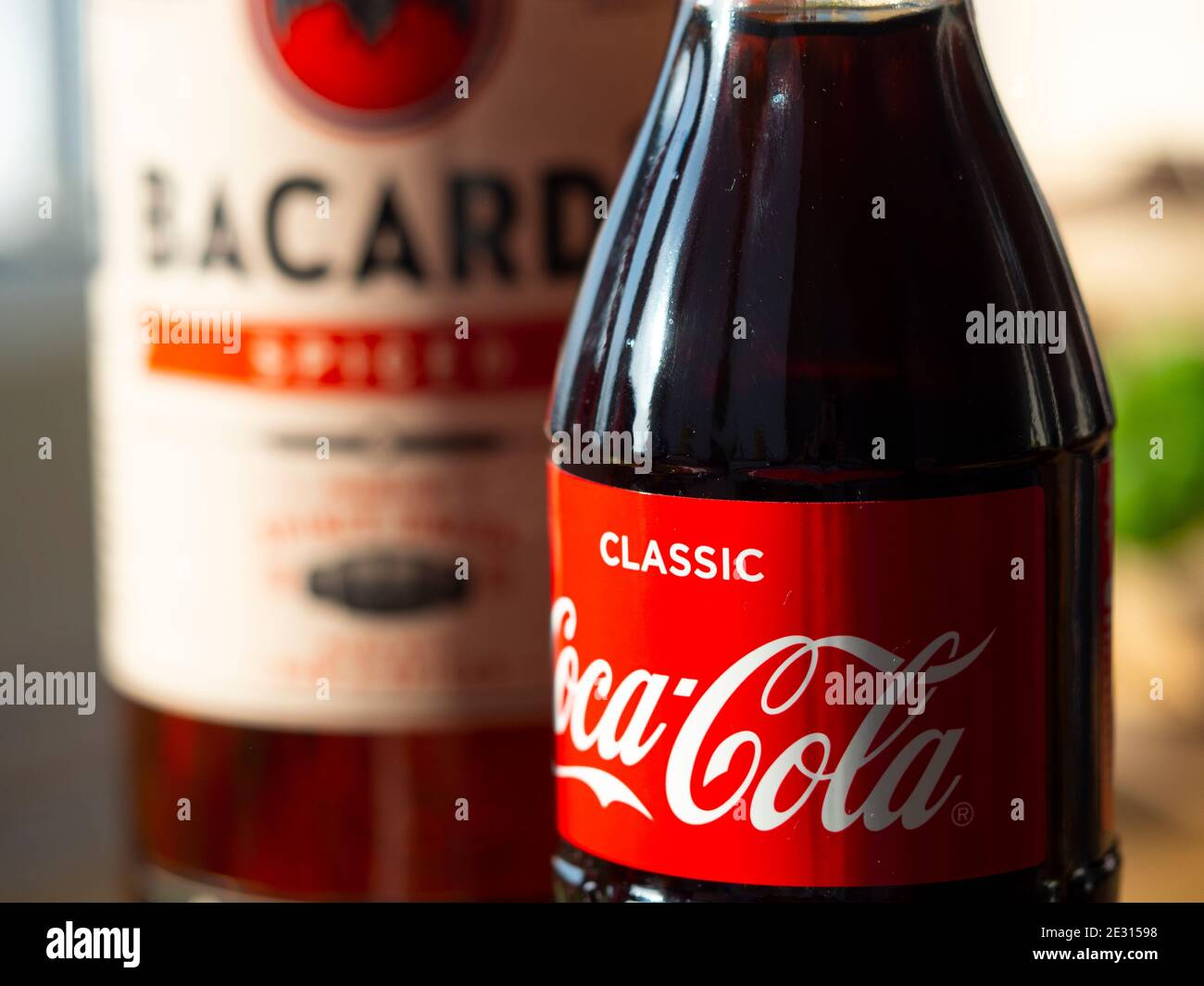 In this photo illustration seen glass bottle of Coca-Cola and Bacardi spiced rum Stock Photo