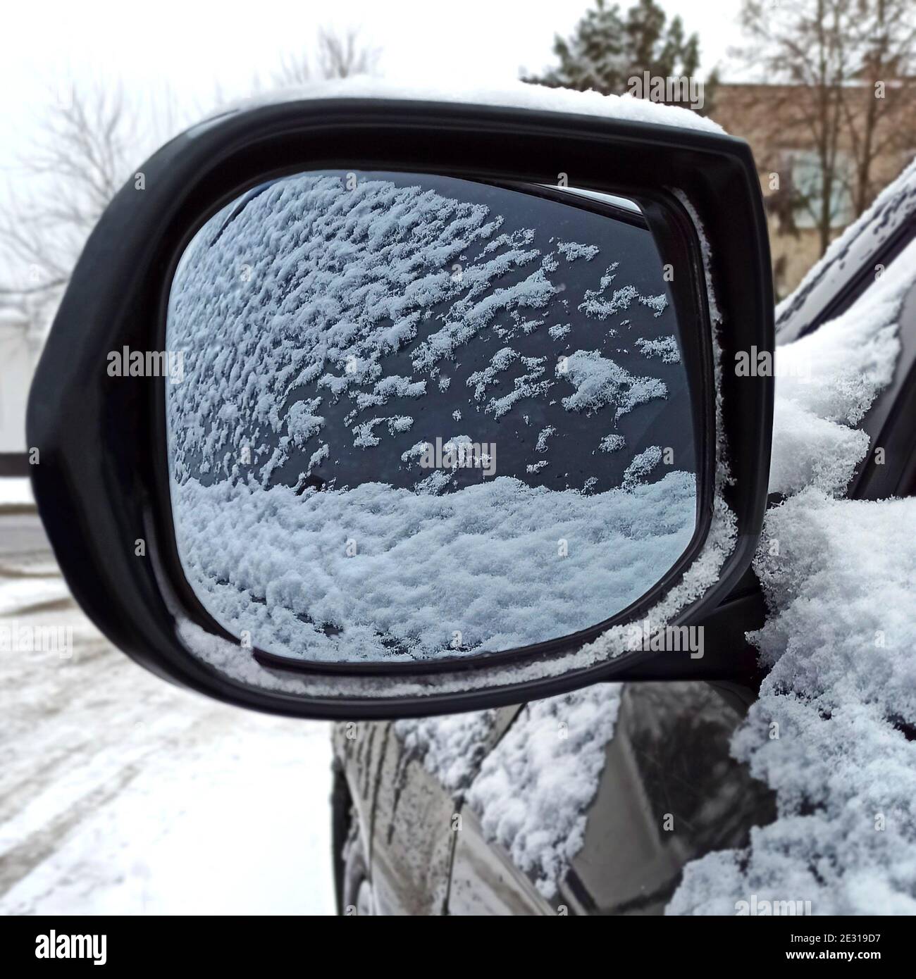 Car covered with snow, reflected in the side mirror Stock Photo Alamy