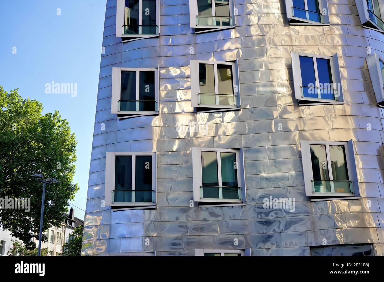 Close-up of a modern building designed by the American star architect Frank O. Gehry. Late afternoon sun reflection. Location: Düsseldorf Medienhafen. Stock Photo