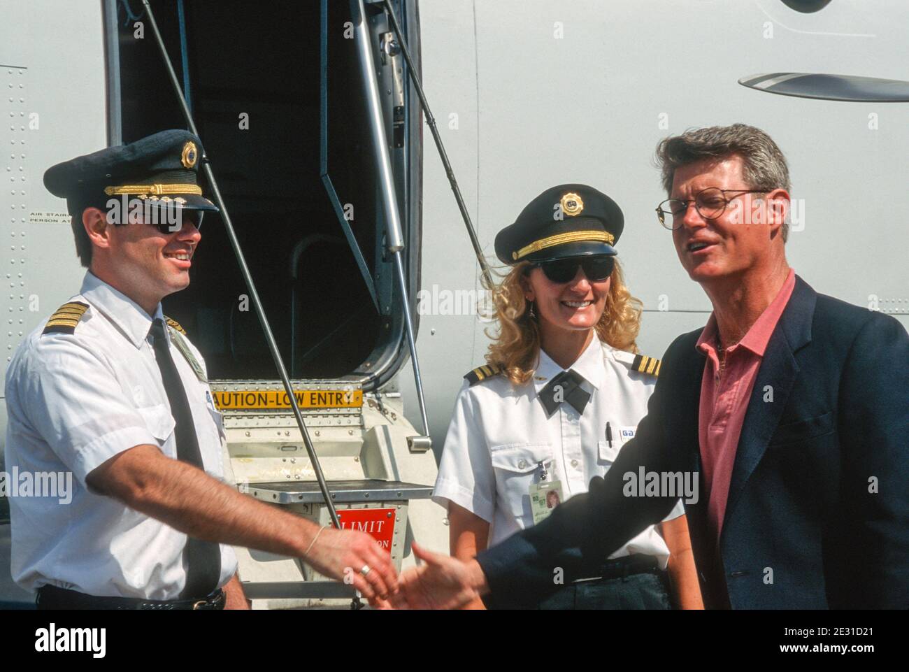 Pilot and His Female CoPilot Greet a Passenger Outside their Commuter