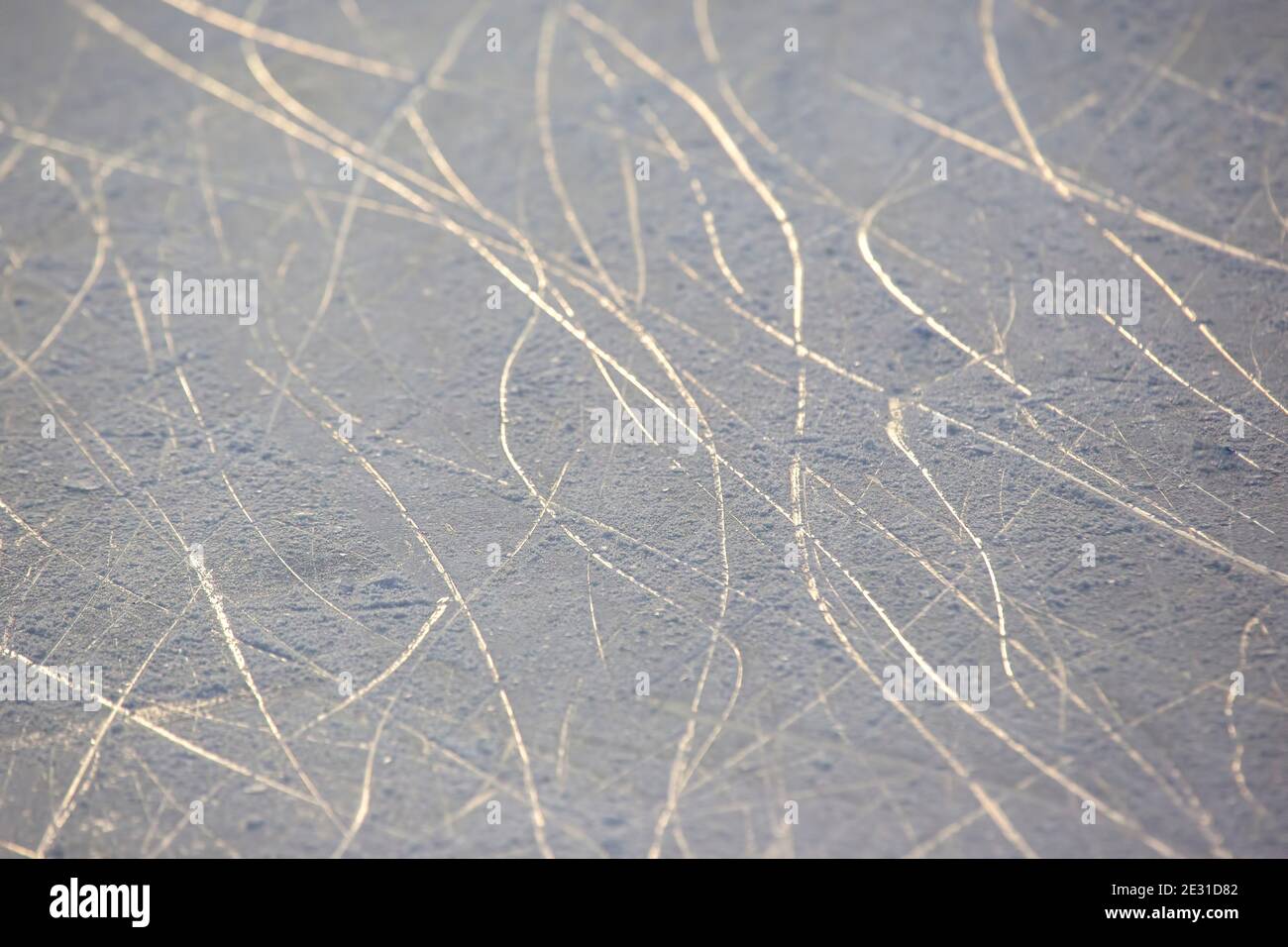 bright traces of ice skating on an ice rink. background and texture Stock Photo
