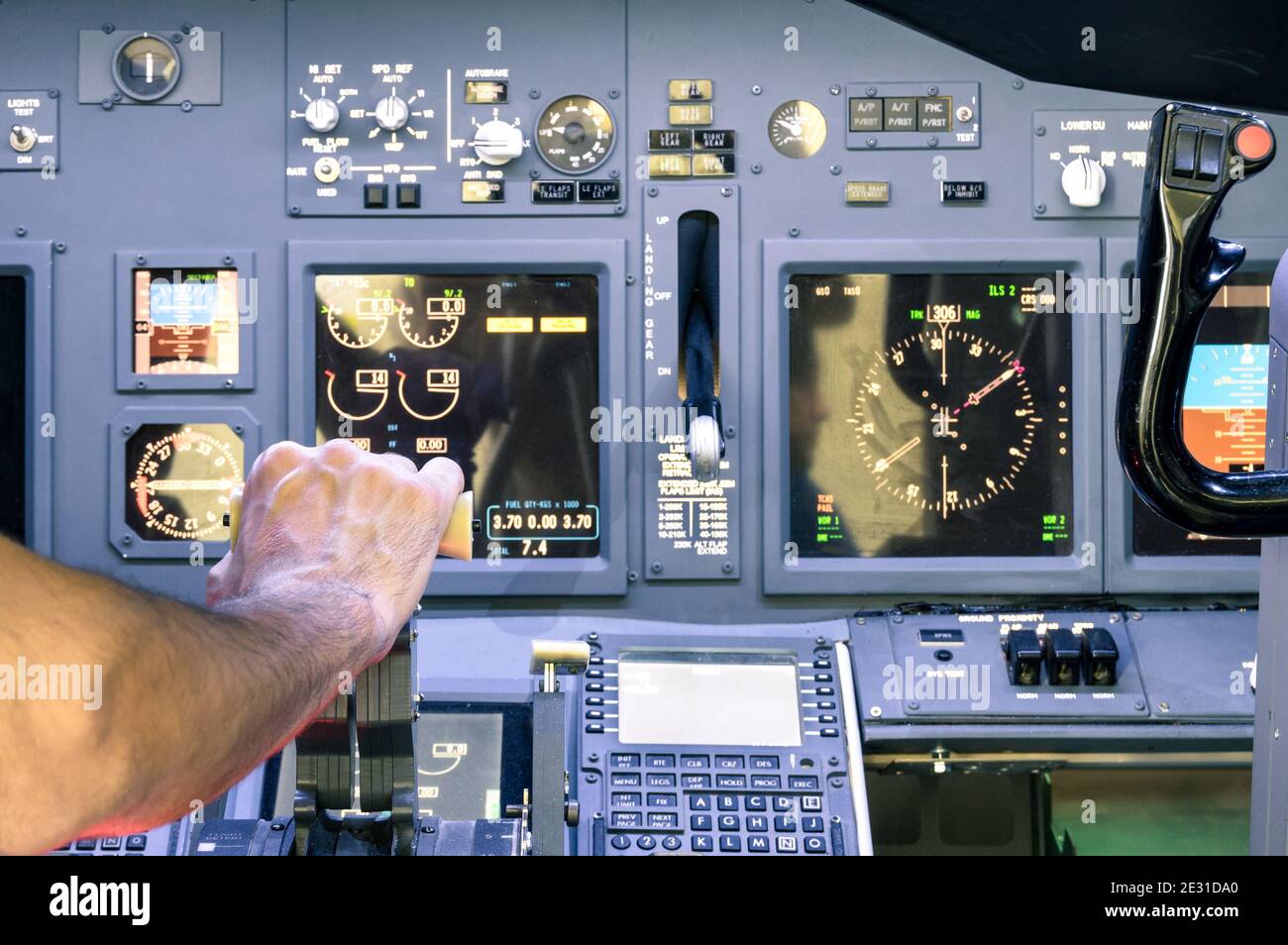 Captain hand accelerating on the throttle in commercial airliner flight simulator - Cockpit thrust levers on the phase of takeoff Stock Photo