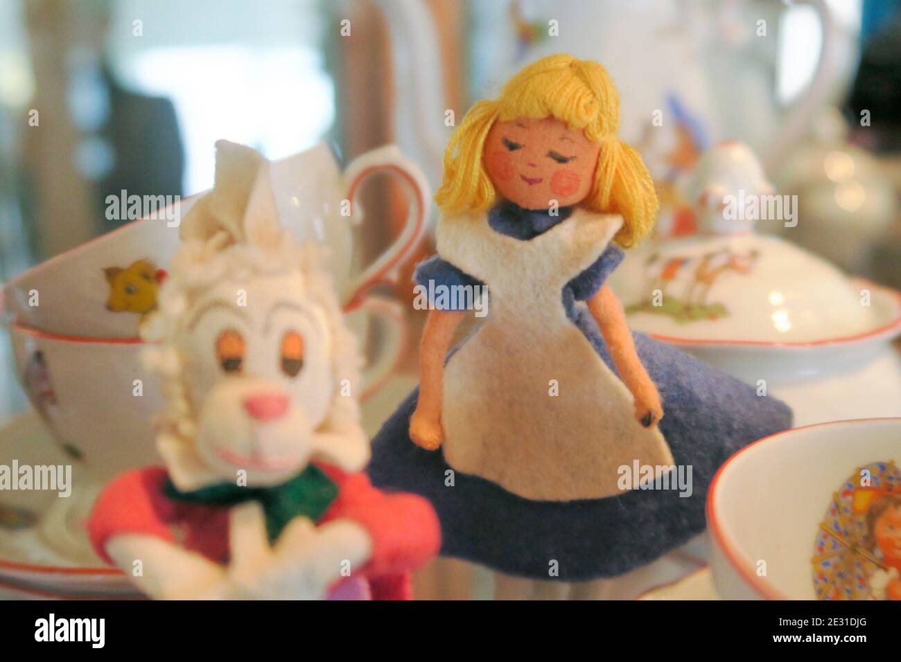 Vintage 1950s fairytale figures among a child's tea set. Stock Photo