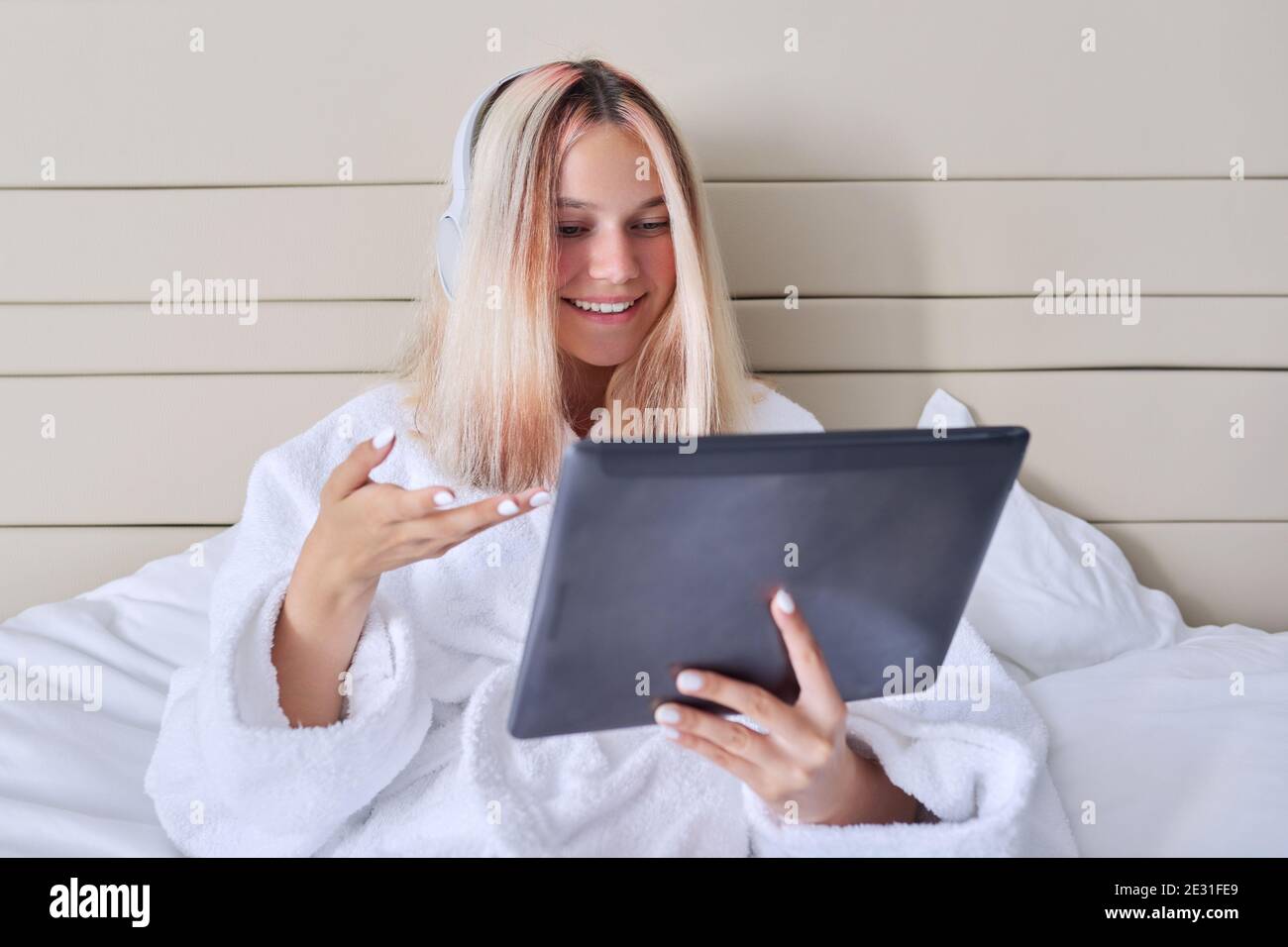 Online communication, video call, teenage girl in headphones with ...