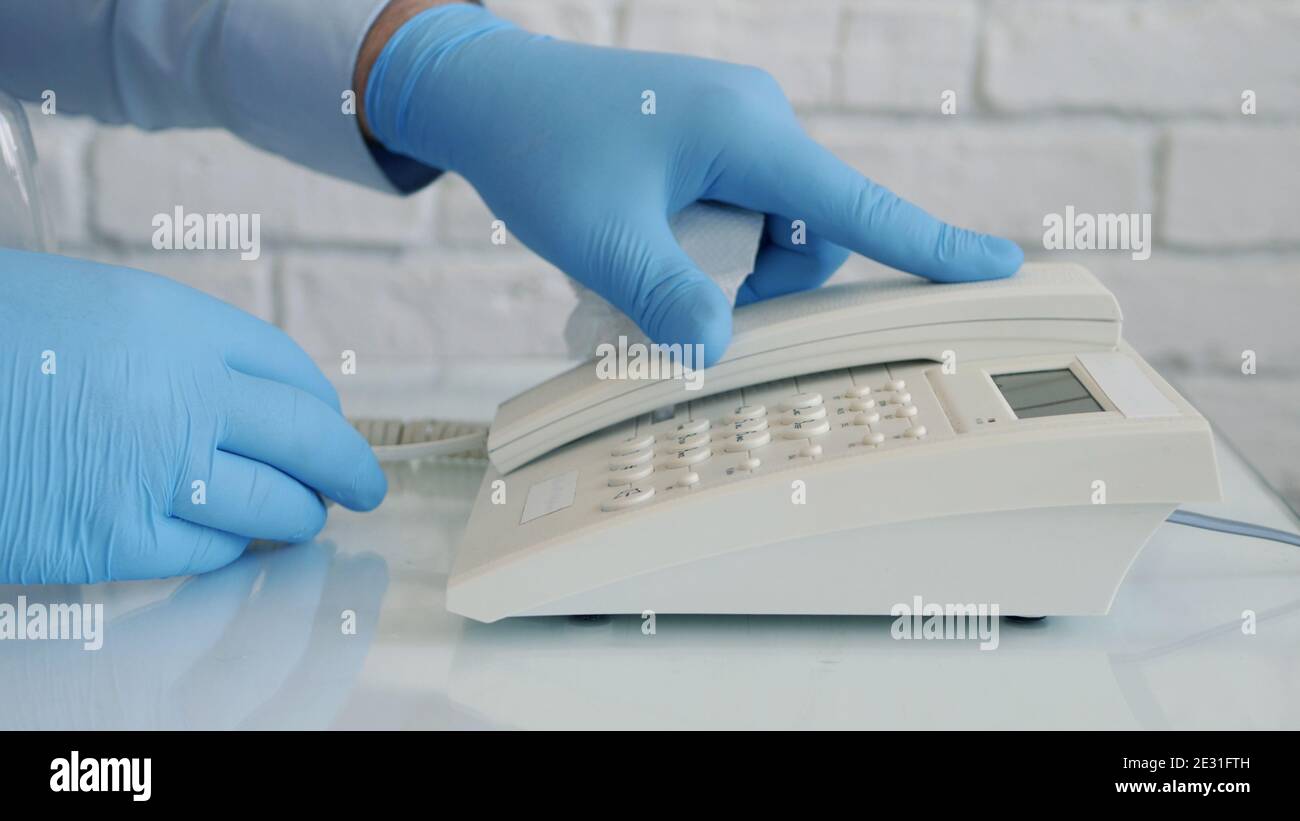 Image with Businessman Hands Wearing Protective Gloves Using Telephone Stock Photo