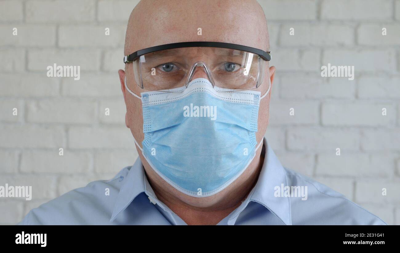 Engineer Portrait Wearing Protective Eyeglasses, and Medical Face Mask in Coronavirus Pandemic Stock Photo