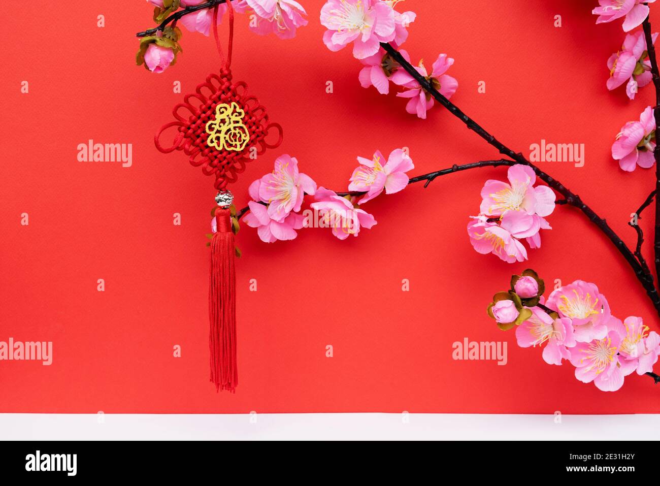 Sakura Cherry Blossom and Ornaments With Chinese Script - Prosperity on Red Backgrounds with Copy Space Stock Photo