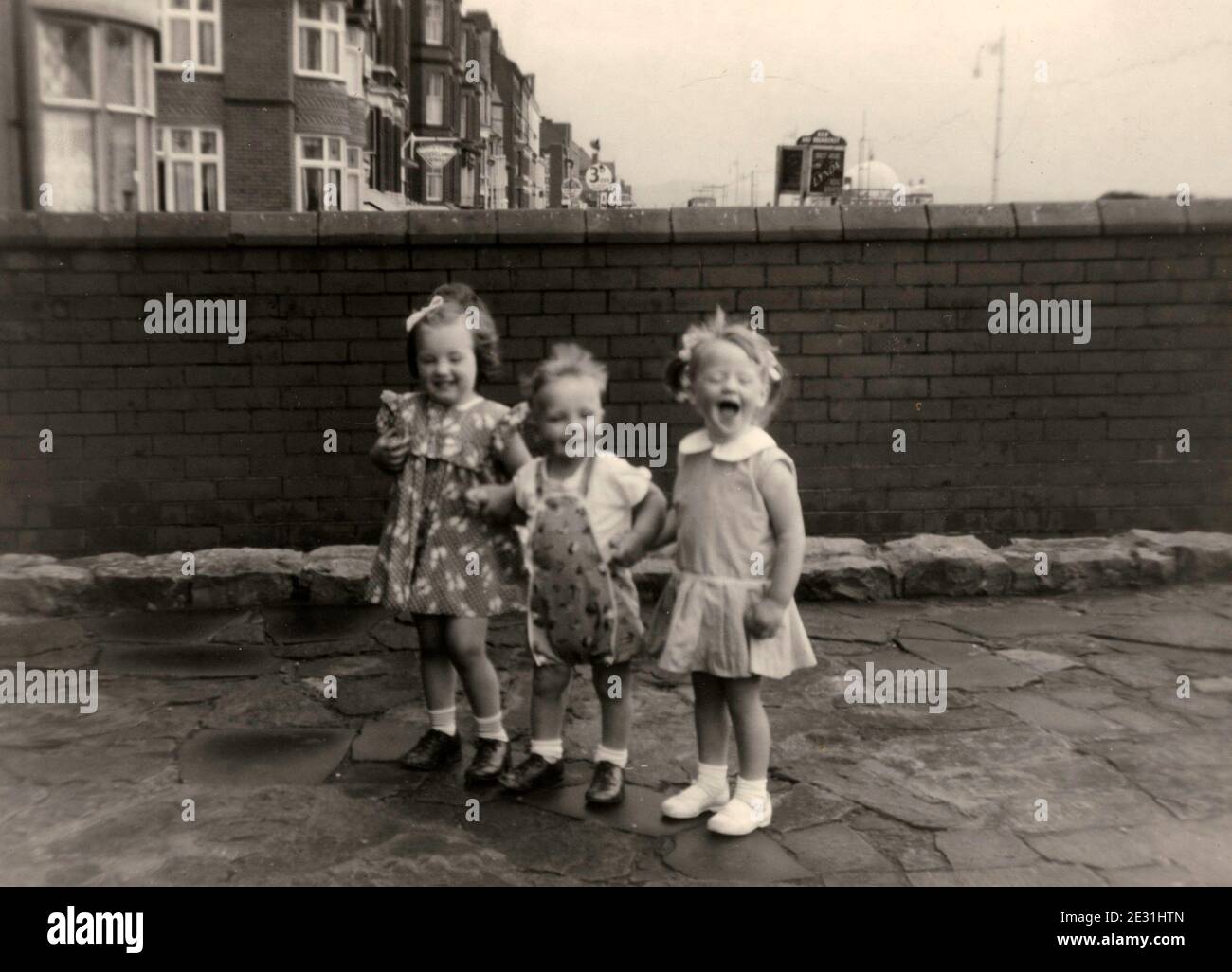1960's children on holiday outside their bed and breakfast accommodation, Blackpool, Lancashire, UK Stock Photo