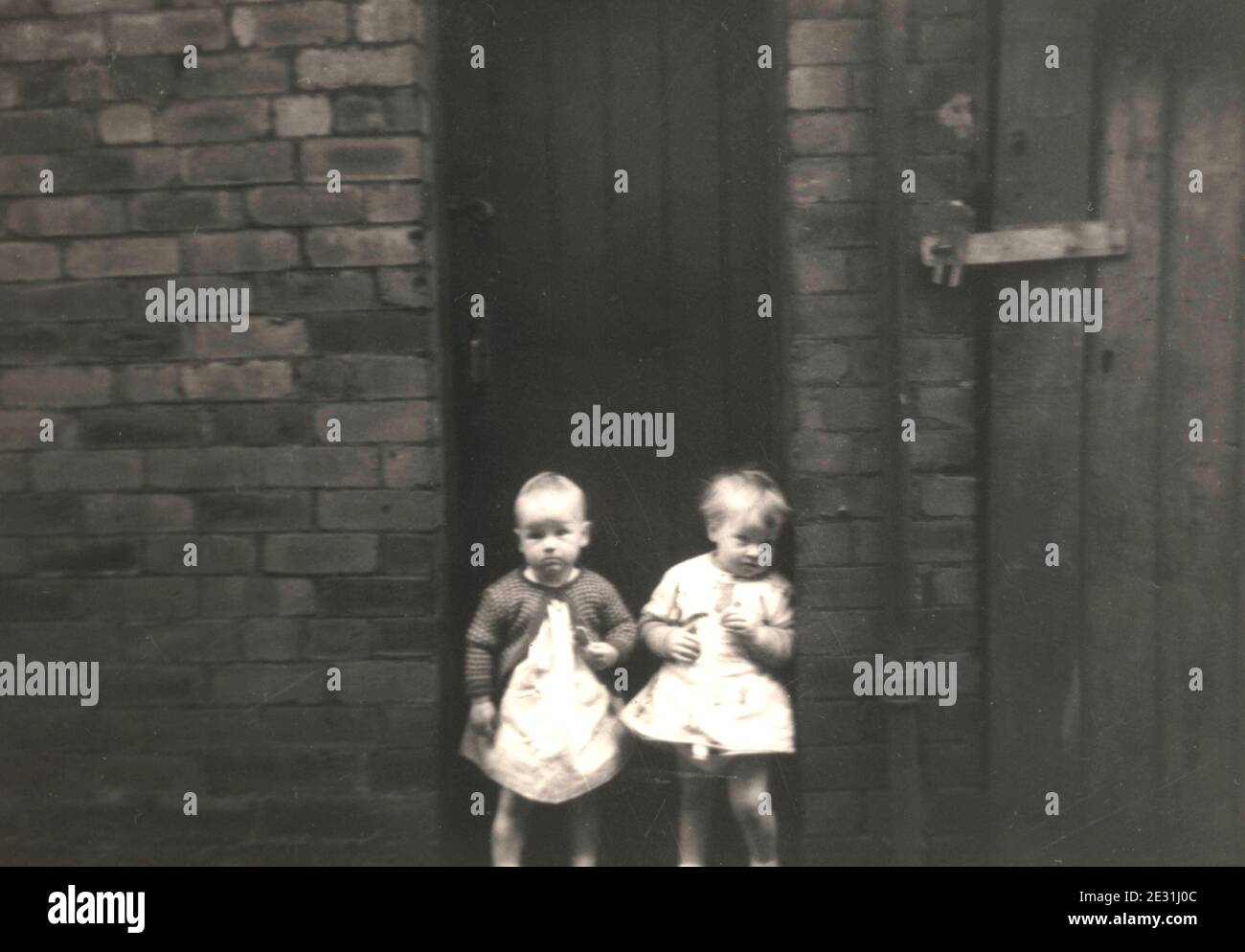 Children in poor terraced housing with outside toilets in the UK in the  1960's Stock Photo