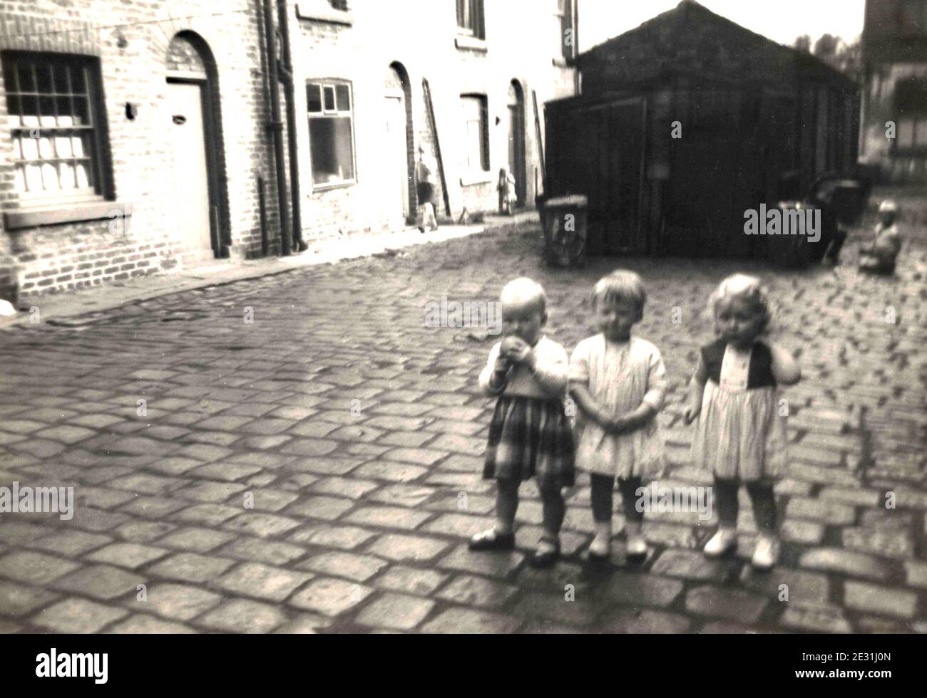 Children in poor terraced housing with outside toilets in the UK in the  1960's Stock Photo