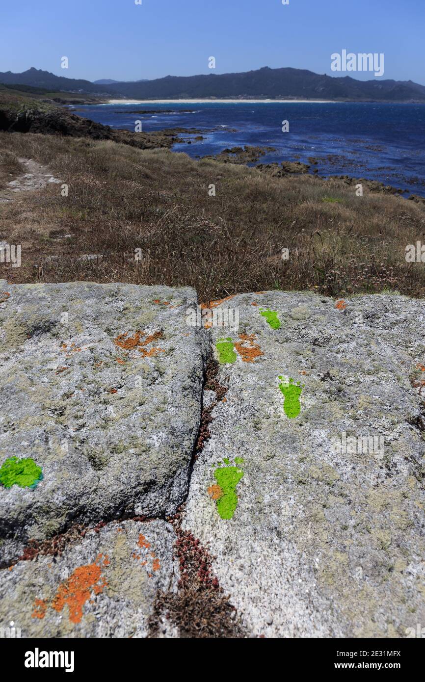 The Lighthouse way trekking route signs painted on the path, Laxe to Arou section, La Coruña (Coruna) province, Galicia, Spain Stock Photo