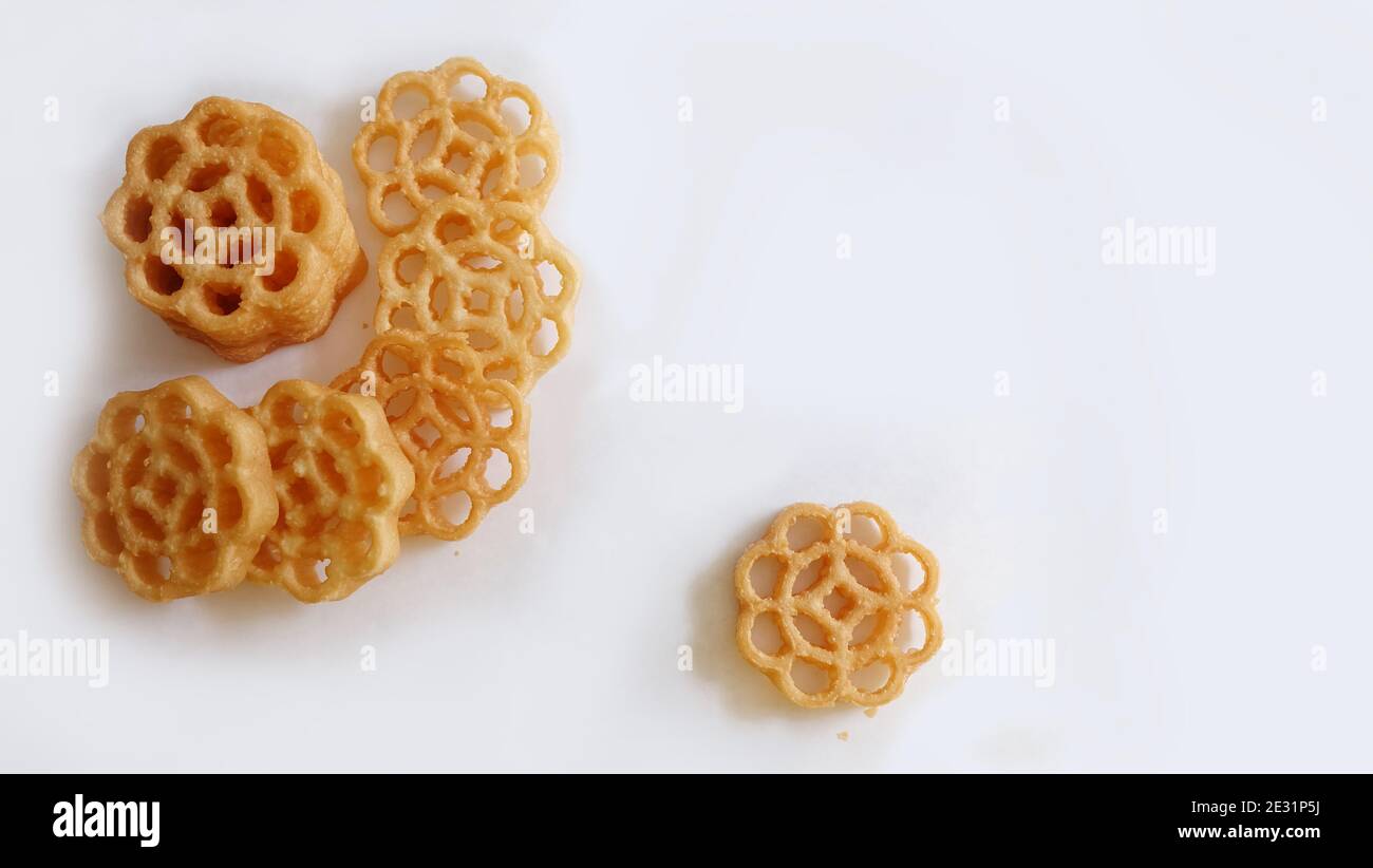Flat lay of honeycomb cookies, also known as kuih loyang in Malaysia, is a popular deep-fried sweet snack during festivals. Stock Photo