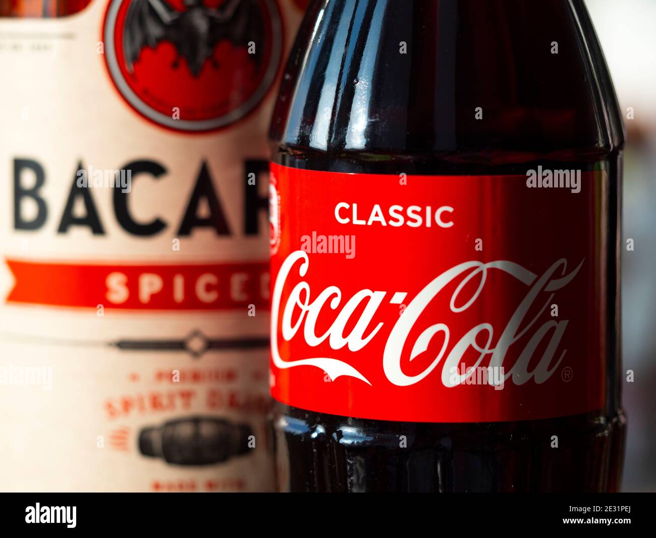 Ukraine. 16th Jan, 2021. In this photo illustration a glass bottle of Coca-Cola and Bacardi spiced rum seen displayed. Credit: SOPA Images Limited/Alamy Live News Stock Photo
