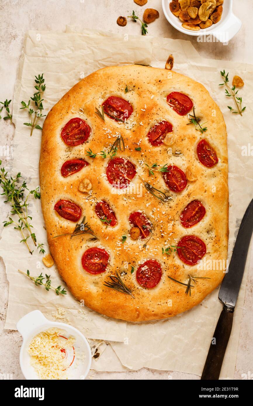 Italian traditional focaccia bread baking with with cherry tomatoes ... Italian traditional focaccia bread baking with with cherry tomatoes ...