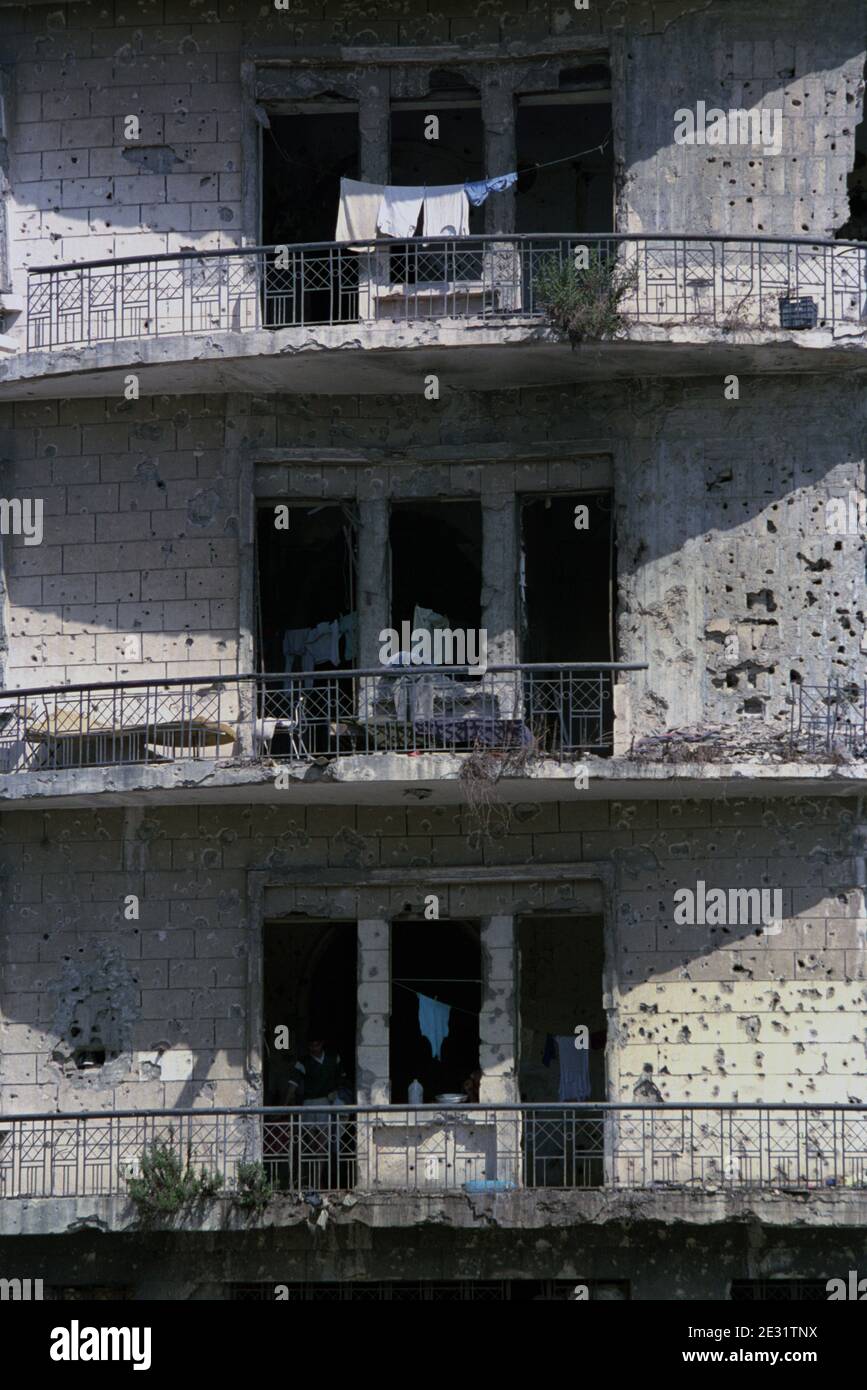18th September 1993 After 15 years of civil war, life goes on in a battle-scarred building near the Green Line in Beirut. Stock Photo