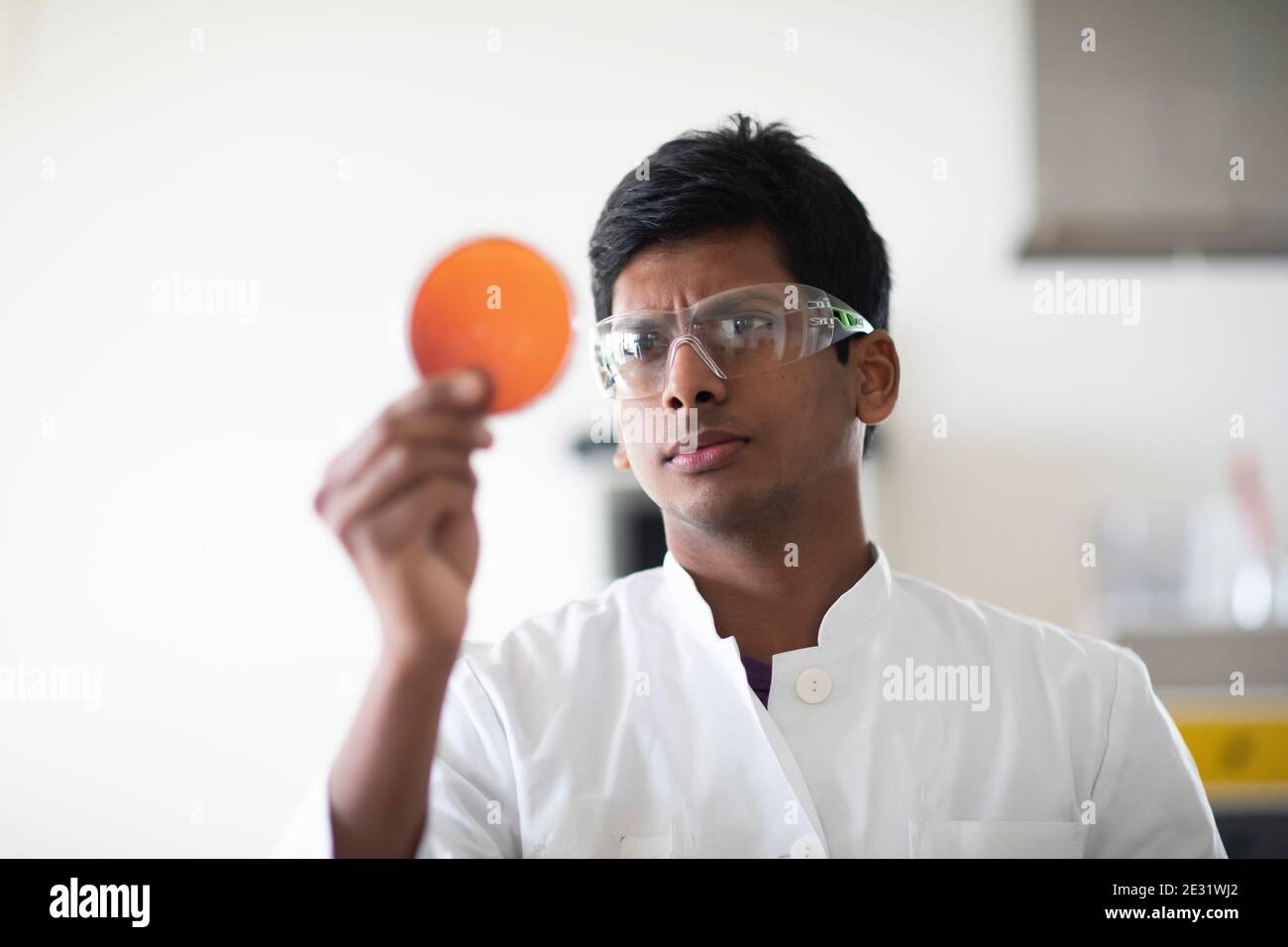 young man technician with labcoat and glasses working Stock Photo