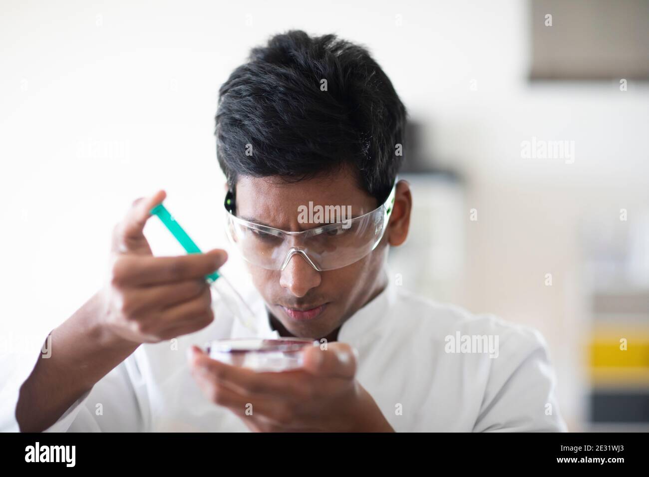 young man technician with labcoat and glasses working Stock Photo
