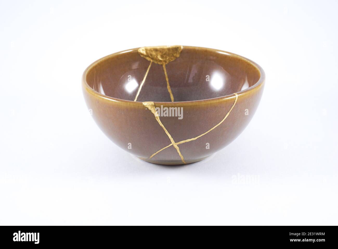 Japanese Kintsugi brown bowl restored with gold Stock Photo