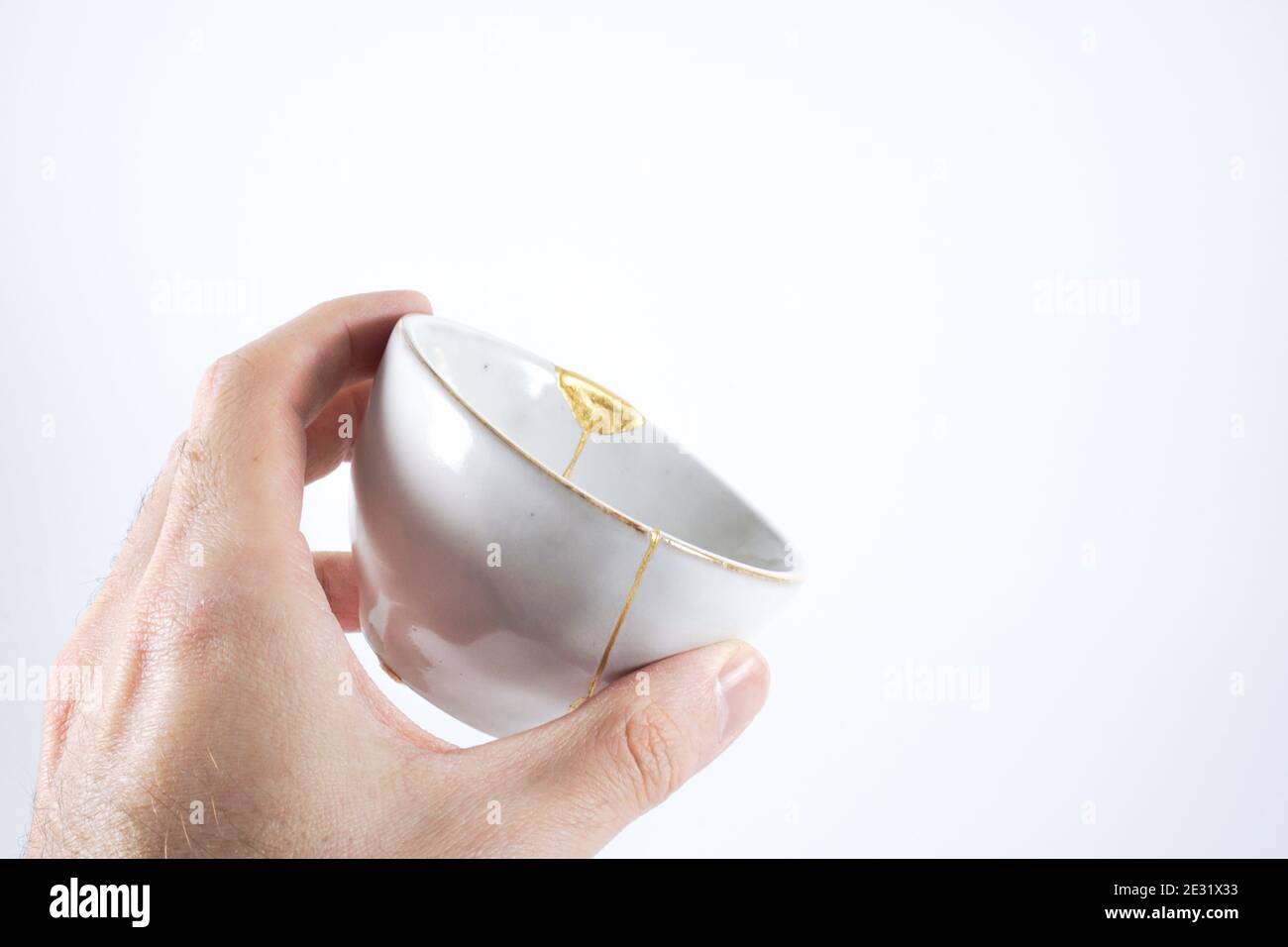 Gray Kintsugi bowl, real gold restoration, japanese technique Stock Photo
