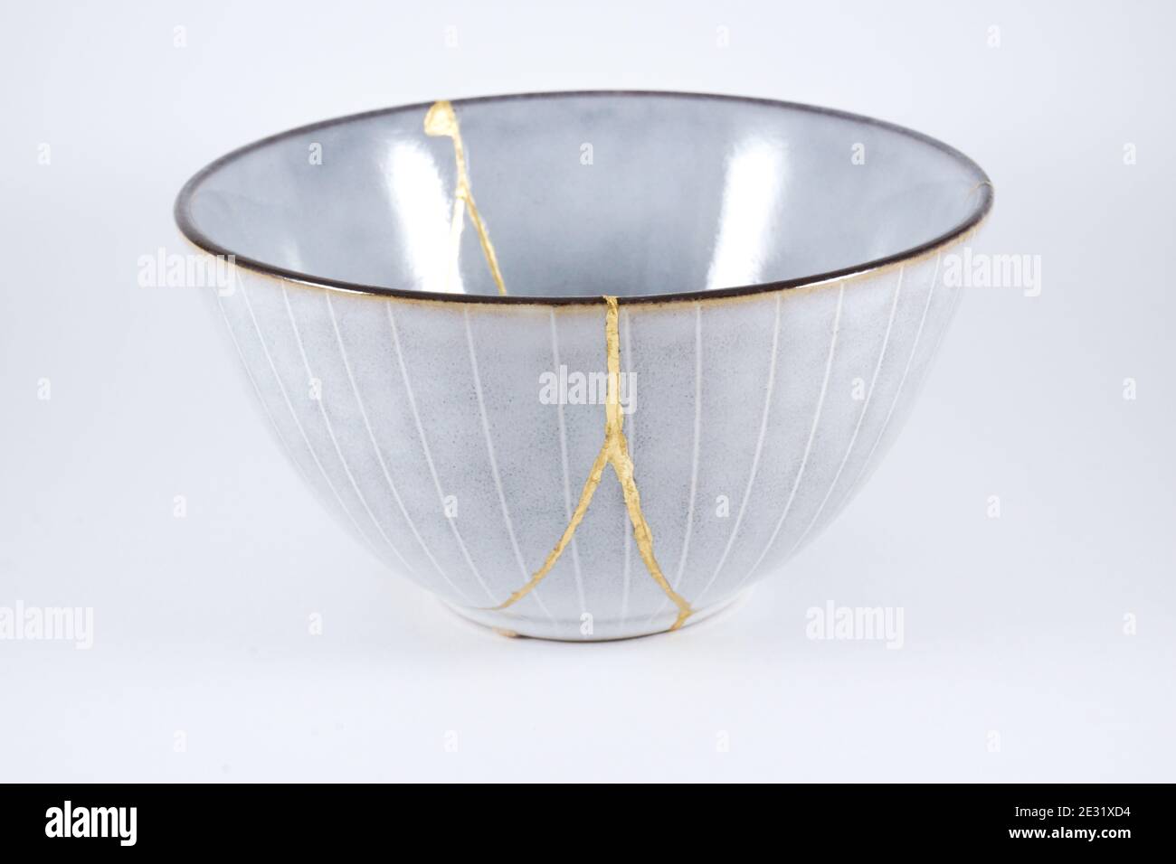 Gray Kintsugi bowl, real gold restoration, japanese technique Stock