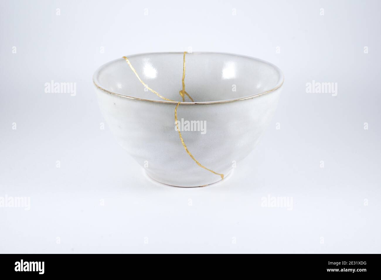 Gray Kintsugi bowl, real gold restoration, japanese technique Stock Photo
