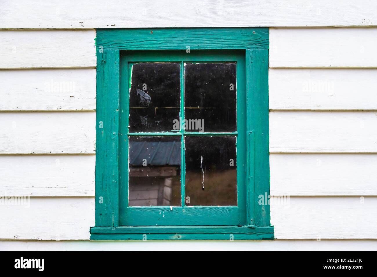 And old window and windows frame painted in green on a building with ...