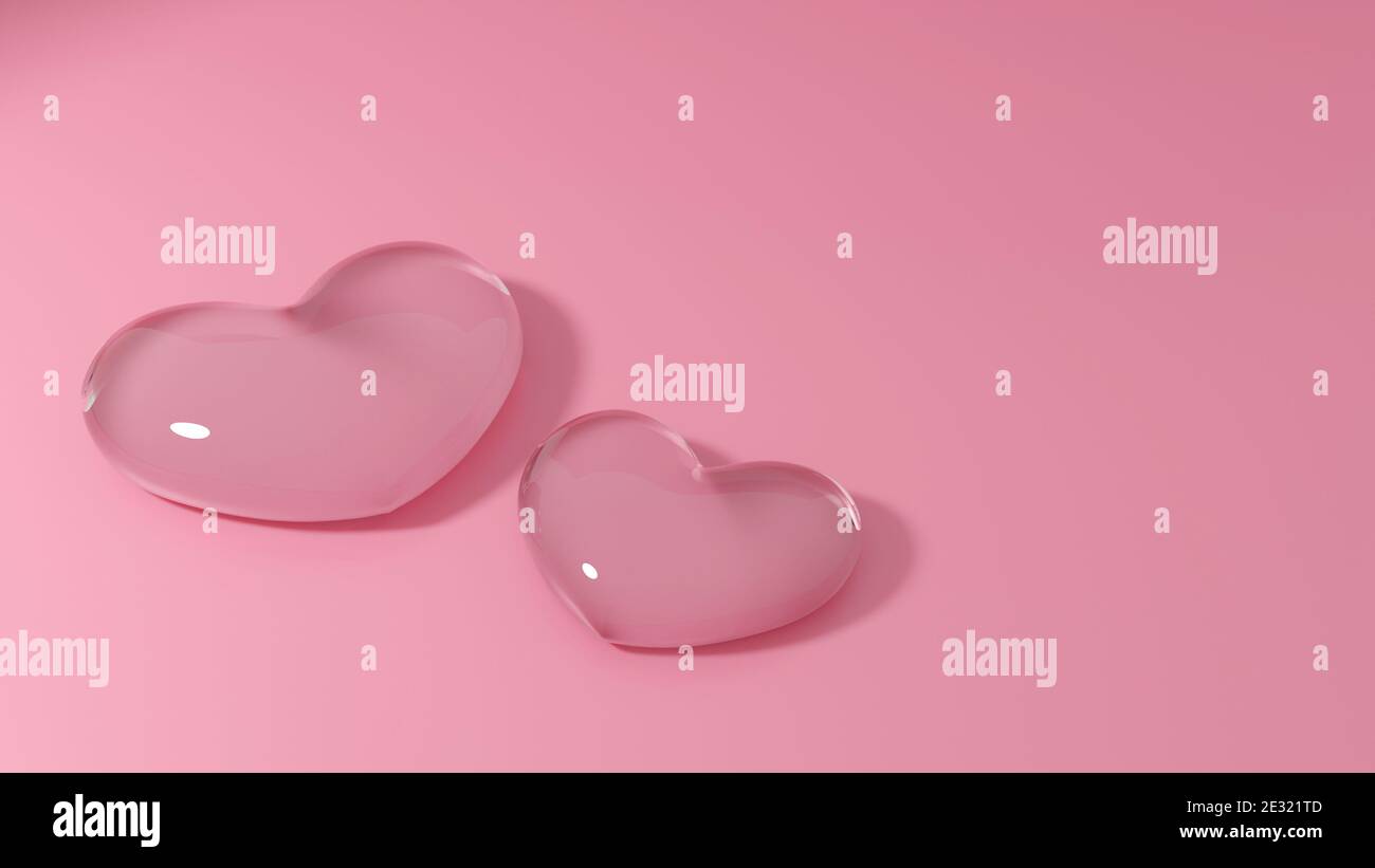 Couple hearts from transparent glass on pink background. Love symbol for wedding or valentines day. Stock Photo