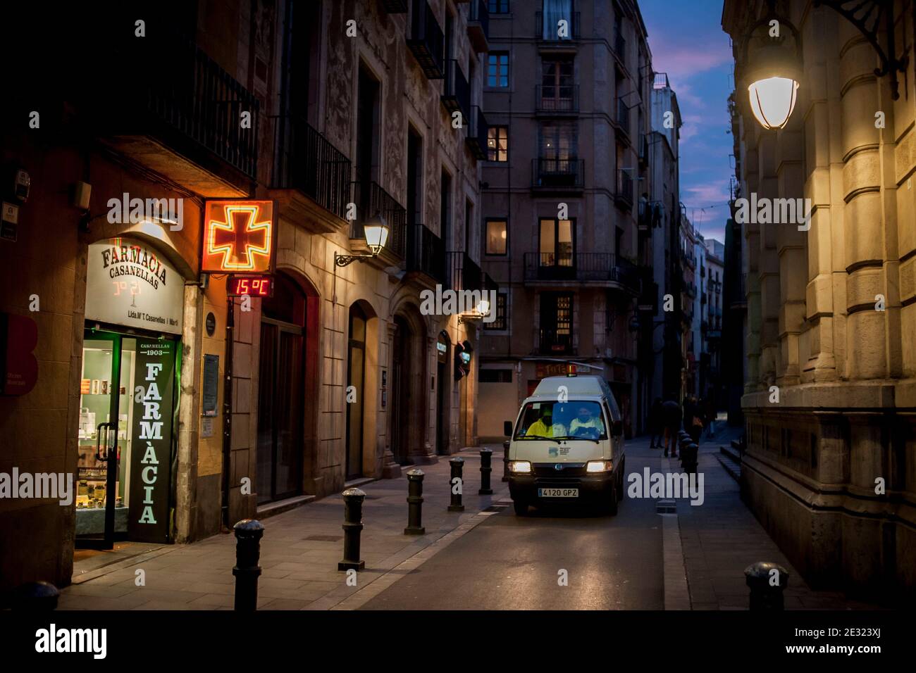A municipal cleaning vehicle passes by  a pharmacy in the streets of the Gothic Quarter in Barcelona, current lockdown measures only allow the opening of businesses considered essential during the weekend. Spain reported 35,878 new coronavirus infections and 201 deaths, as third wave numbers rise. Stock Photo