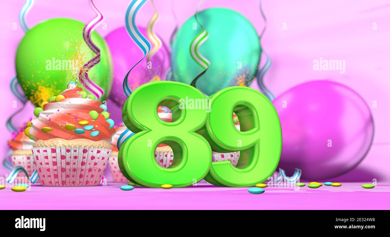 Birthday cupcake with sparking candle with the number 89 large in green with cupcakes with red cream decorated with chocolate chips and balloons on th Stock Photo