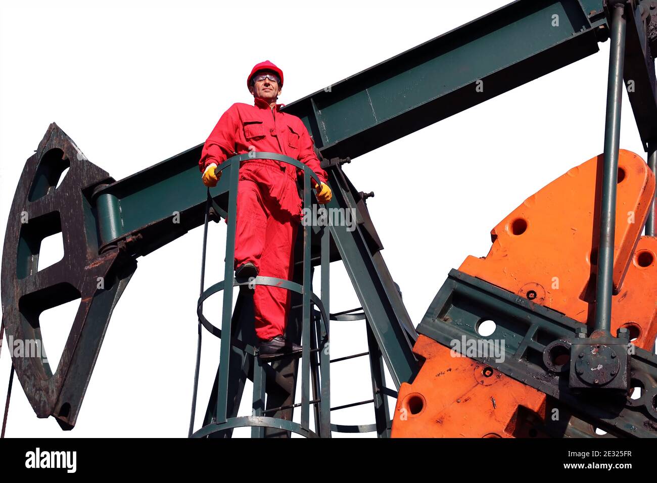 Worker in Red Coveralls and Personal Protective Clothing Standing at Pump  Jack Pumping Unit. Petroleum Worker in an Oil field Stock Photo - Alamy