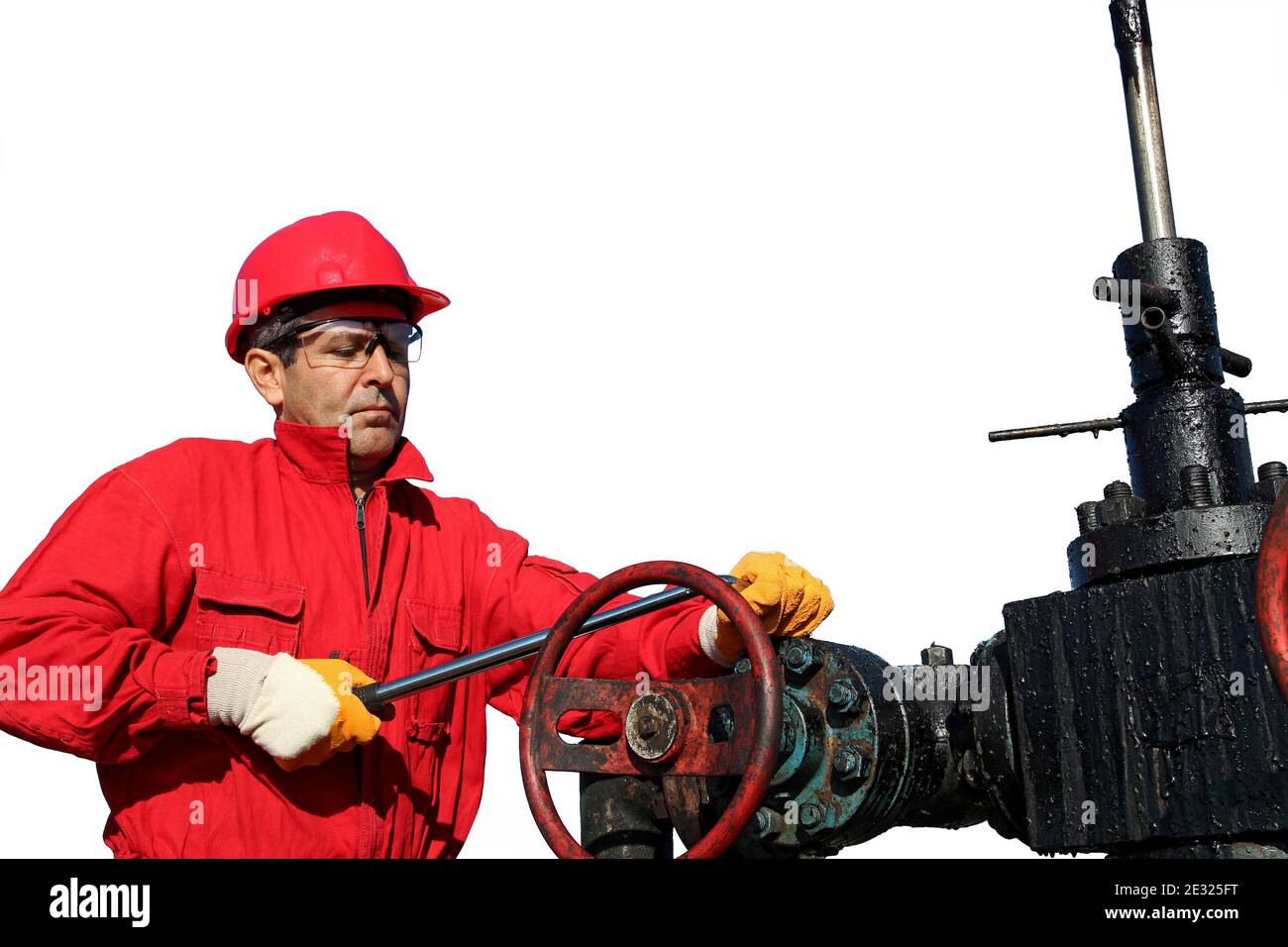Petroleum Worker in Red Coveralls and Protective Clothing Servicing Oil Equipment. Oil Rig Equipment Maintenance. Stock Photo
