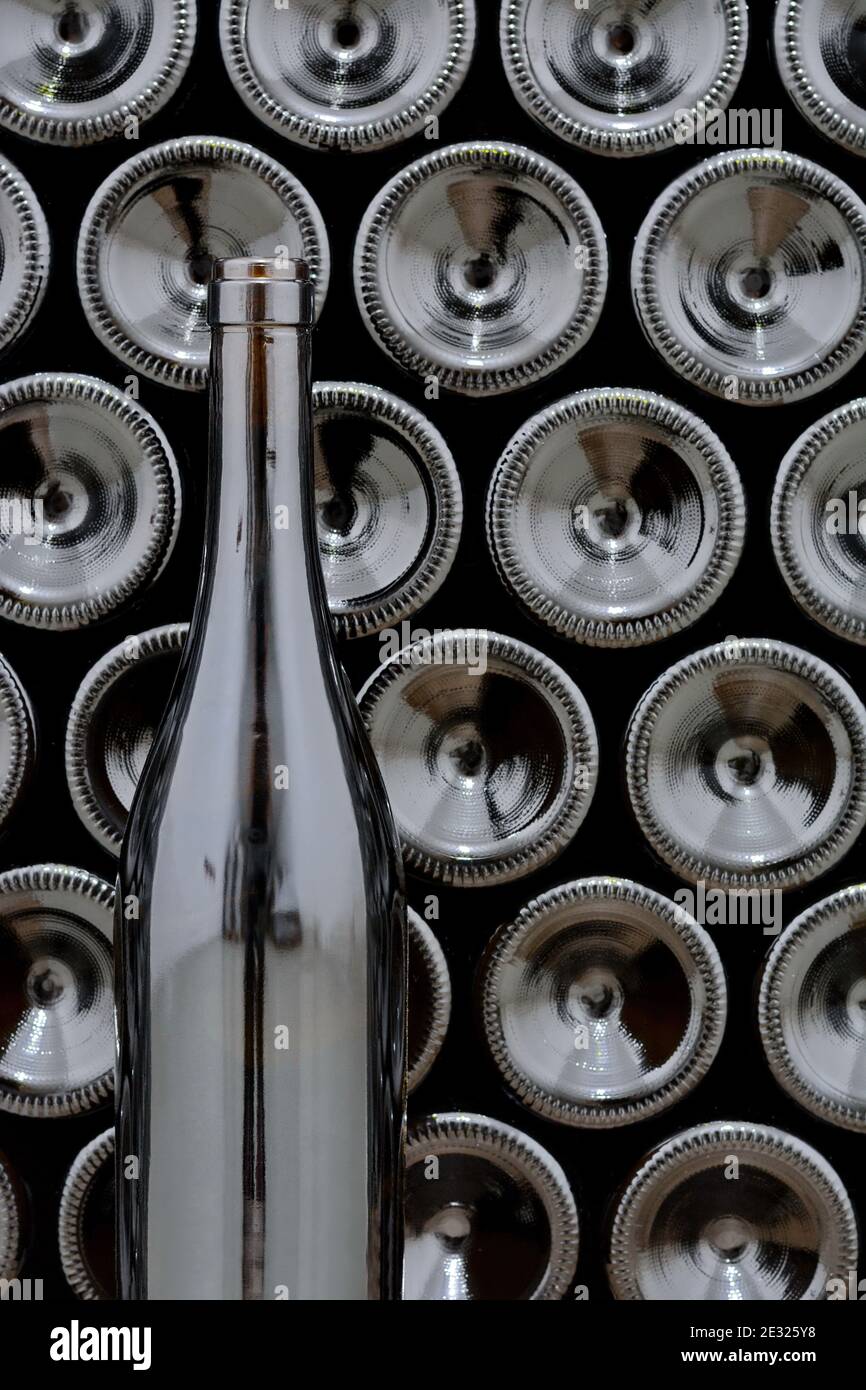 Full bottles of wine, stacked in a winery. Lot of bottles Stock Photo