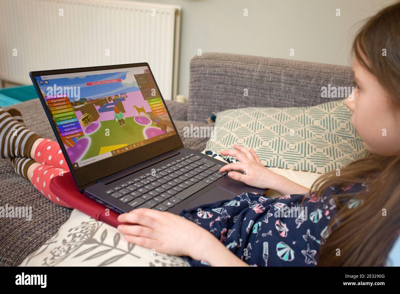 Young girl playing Roblox on laptop computer Stock Photo