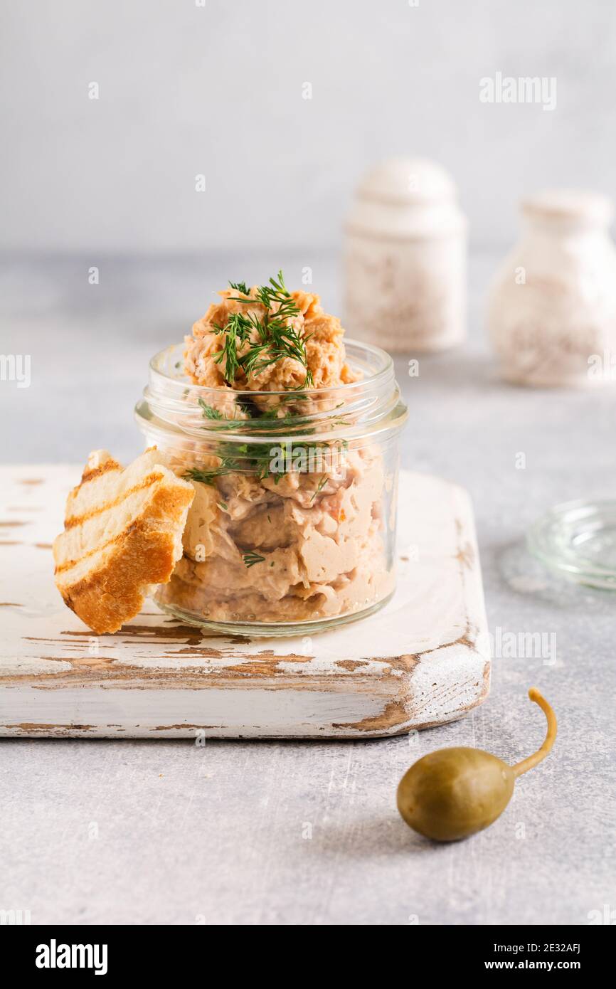Sandwich with chicken pate with caper on a light board background