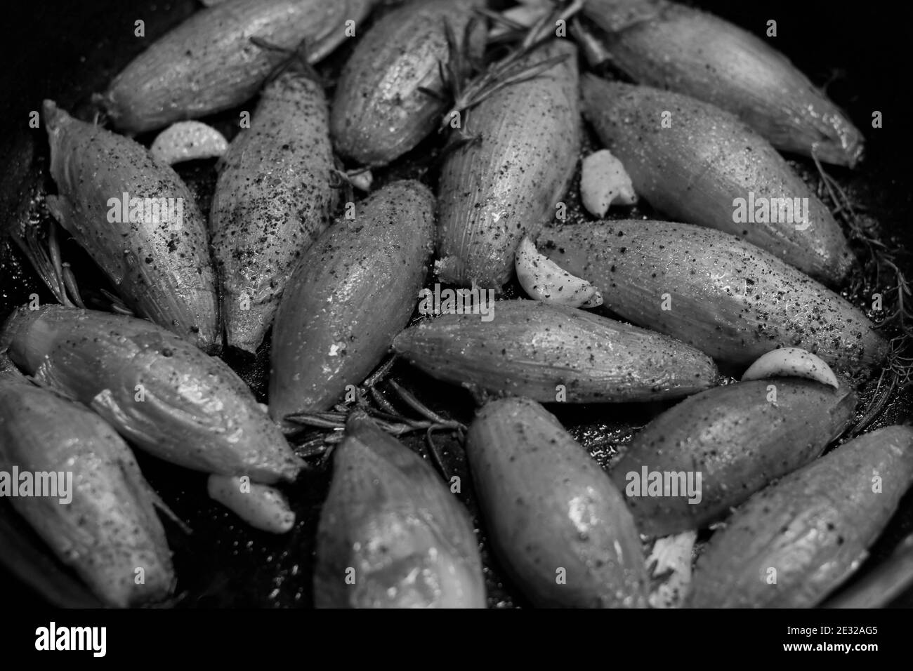 preparation of caramelized banana shallot as beef steak condiment, black and white close up shoot Stock Photo