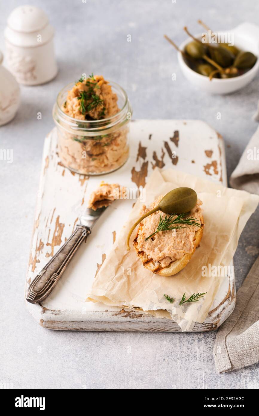 Sandwich with chicken pate with caper on a light board background