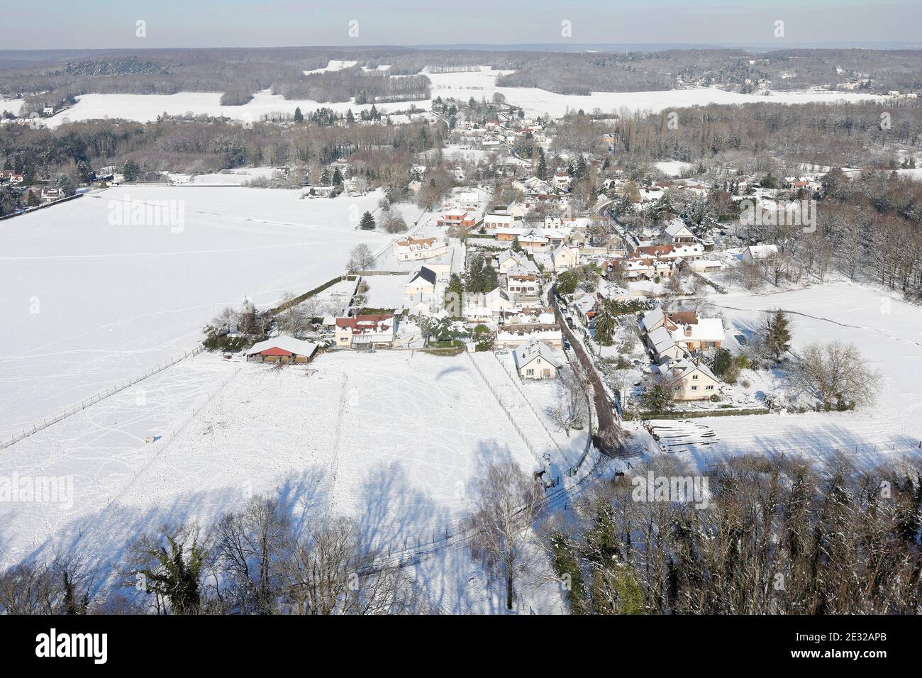 Saint-Cyr-sous-Dourdan under the snow seen from the sky by paramotor on February 08, 2018, Essonne departement, Île-de-France region, France. Stock Photo