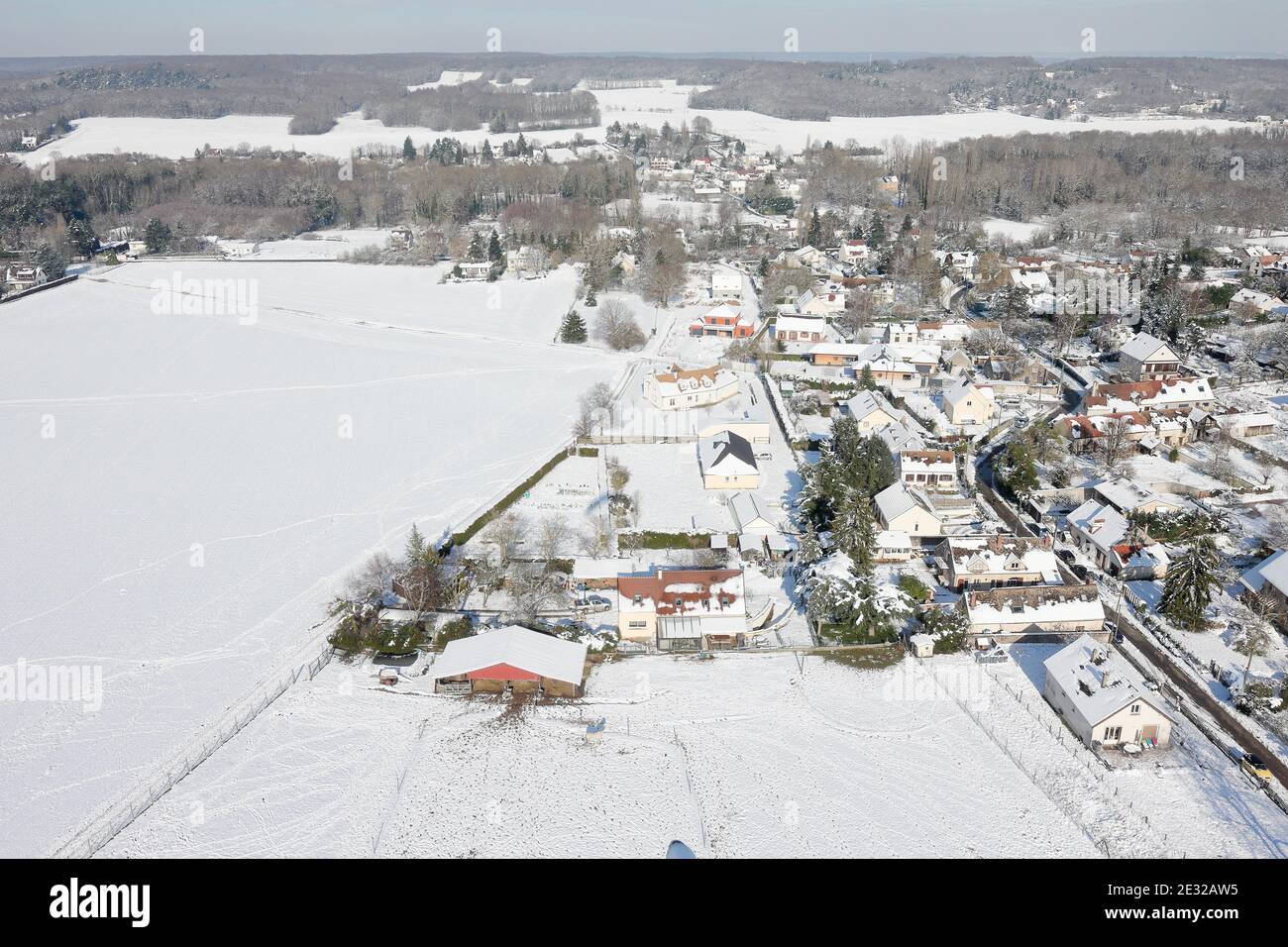 Aerial photo of Saint-Cyr-sous-Dourdan under the snow, seen from the sky by paramotor on February 08, 2018, Essonne departement, Île-de-France region, Stock Photo