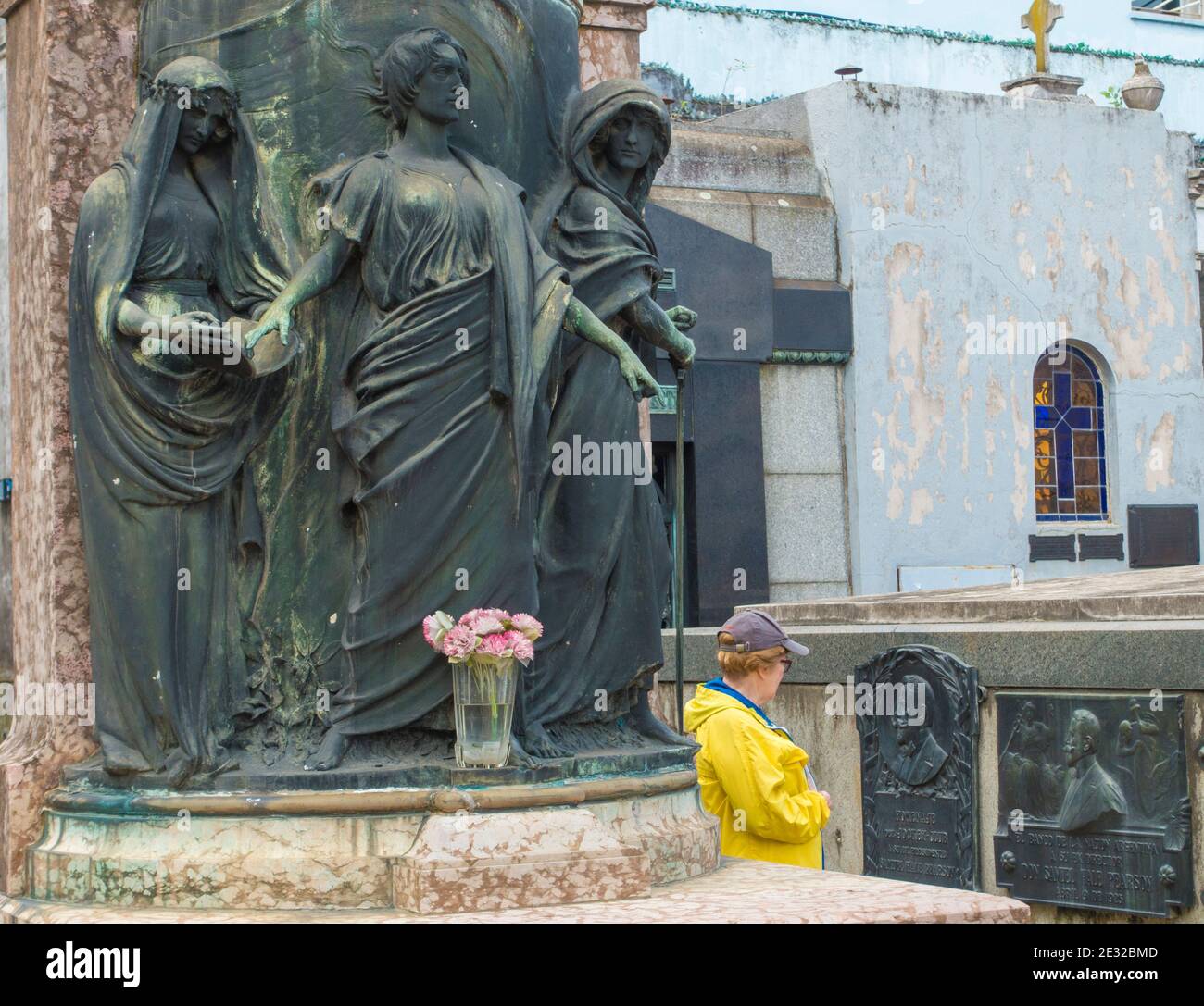 Woman walks among above-ground tombs in Recoleta Cemetery, Buenos Aires, Argentina Stock Photo
