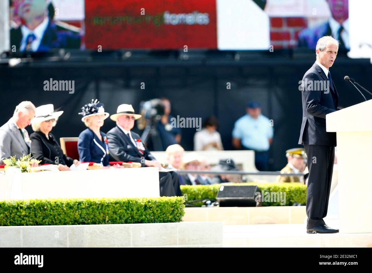 Hubert Falco delivers a speech and behind Britain's Prince Charles of Wales, the Duchess of Cornwall Camilla Parker Bowles, the Governor General of Australia Quentin Bryce and her husband Michael during the burial ceremony of an unknown World War One sold Stock Photo