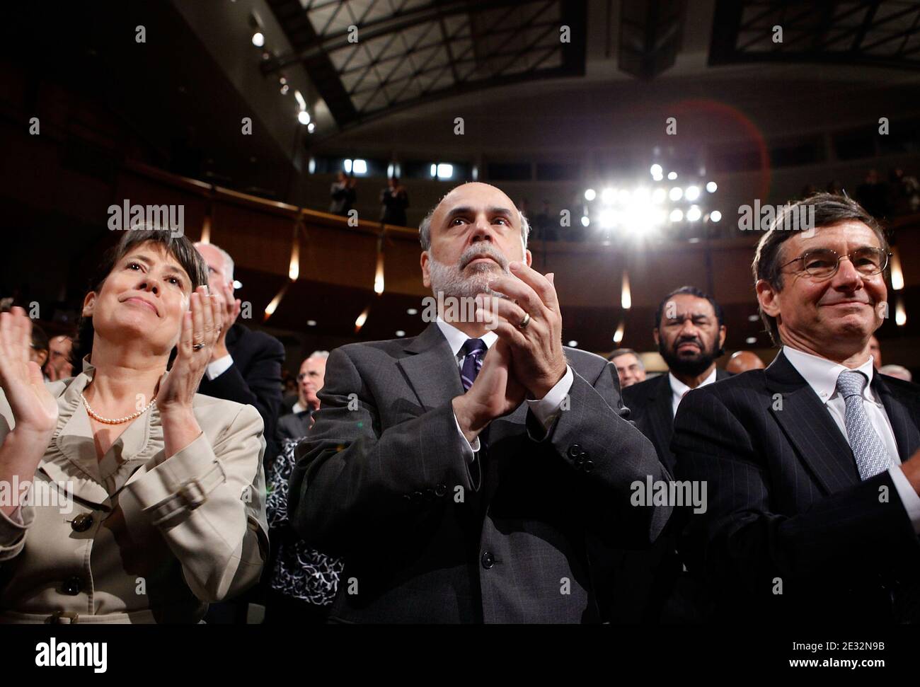 "(L-R) FDIC Chair Sheila Bair, Federal Reserve Bank Chairman Ben Bernanke and California Public EmployeesÀ Retirement System Chief Investment Officer Joseph Dear applaud as U.S. President Barack Obama signs the the financial reform bill into law during a ceremony at the Ronald Reagan Building and International Trade Center July 21, 2010 in Washington, DC. A sweeping expansion of federal financial regulation in the wake of the worst recession since the Great Depression, the bill will create a consumer protection agency, lay out a blueprint for disassembling financial entities considered ""too b Stock Photo