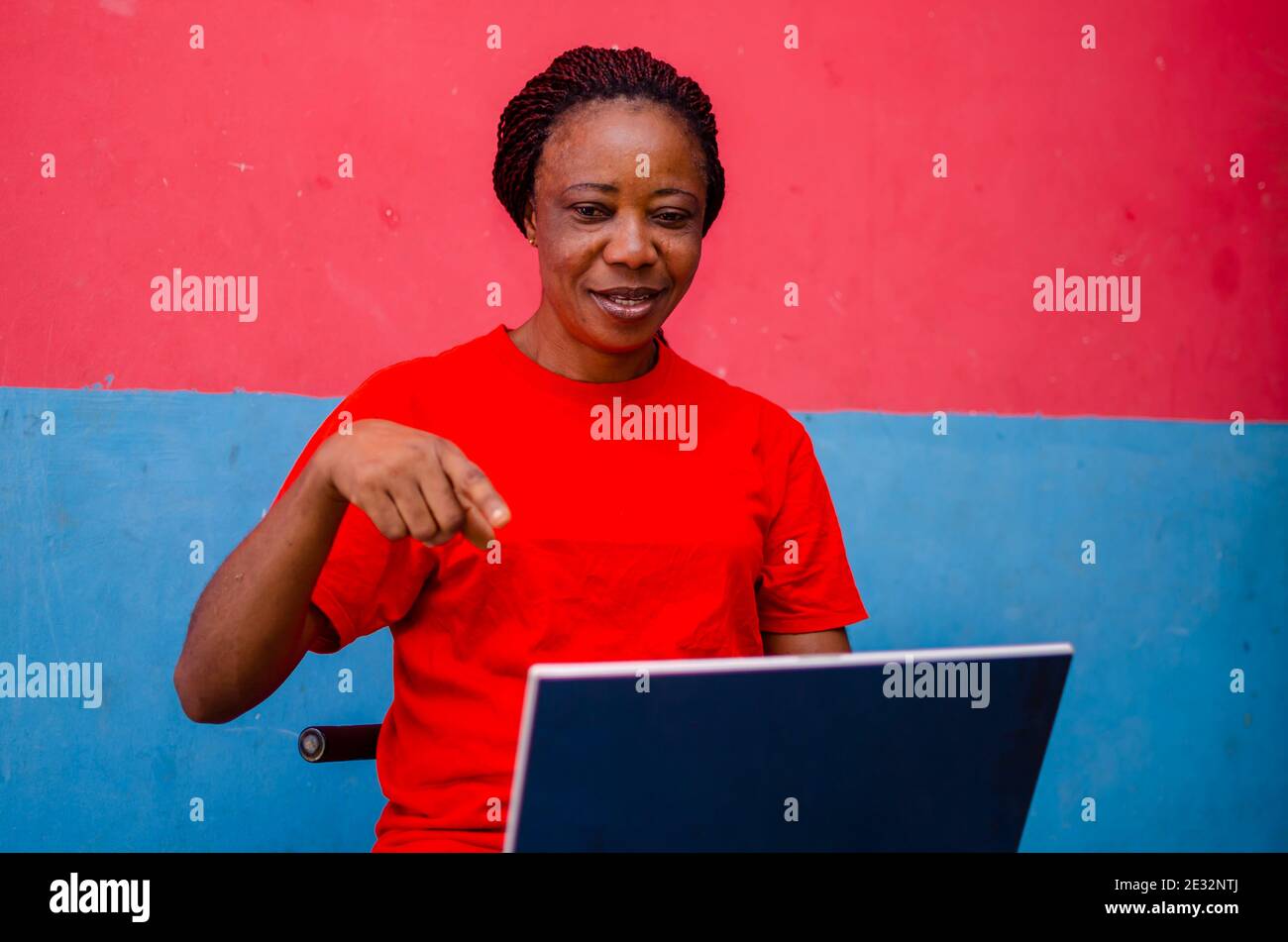 old beautiful african woman pointing to what she saw on her laptop ...