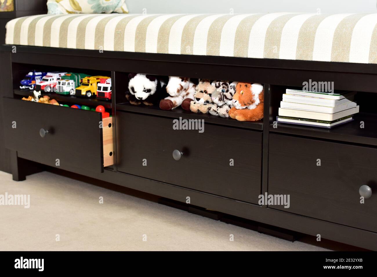 Easy simple home storage solutions for children's play area to clean up toys, games, books, stuffed toys Stock Photo