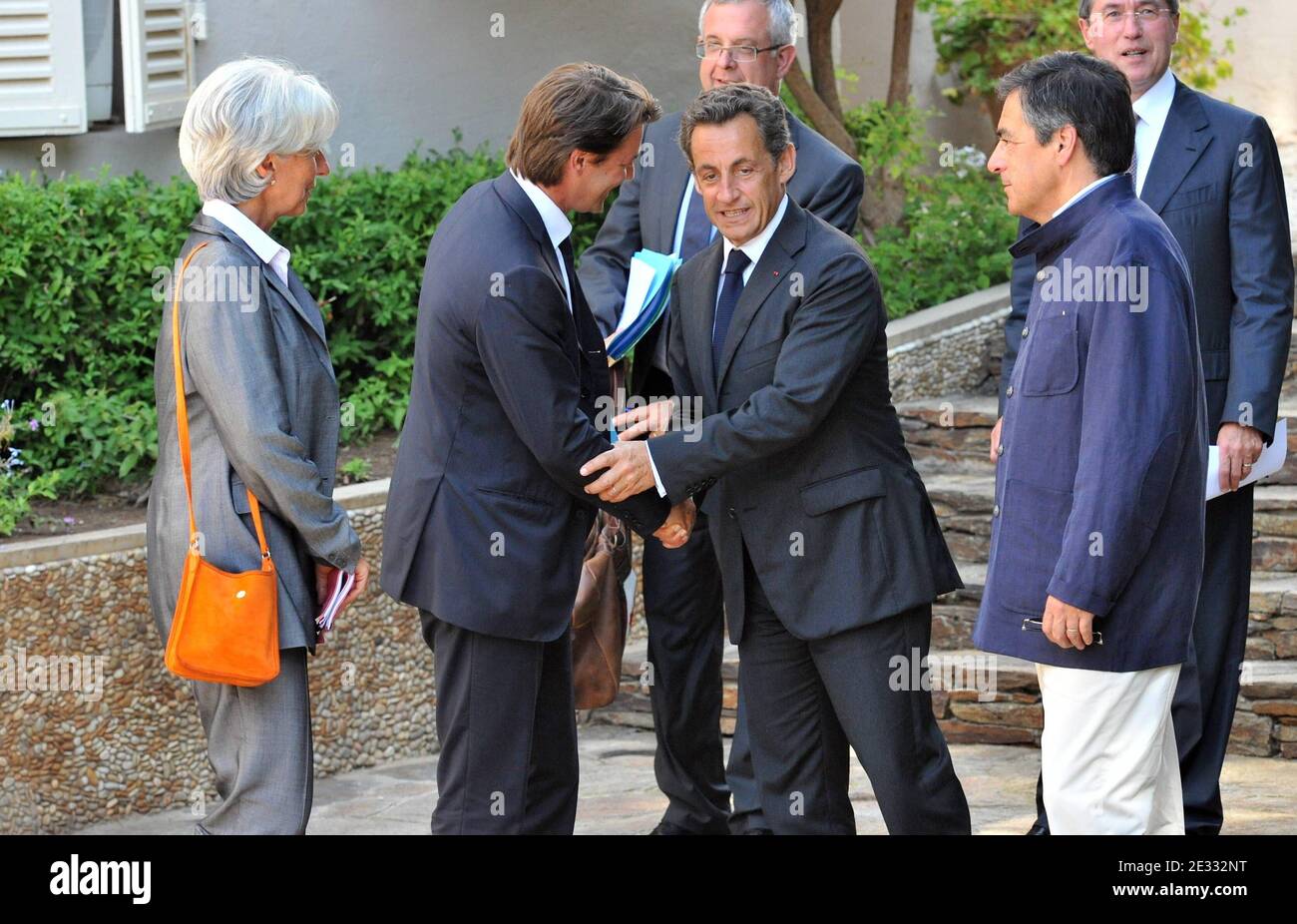 French President Nicolas Sarkozy (C) shakes hands with Budget minister Francois Barouin as Prime Minister Francois Fillon (R) and Economy minister Christine Lagarde (L) look on as they leave the Fort of Bregancon, the presidential summer residence in Bormes-les-Mimosas, southern France on August 20, 2010, after a meeting to tackle the economy and spiralling public deficit. Photo by ABACAPRESS.COM Stock Photo