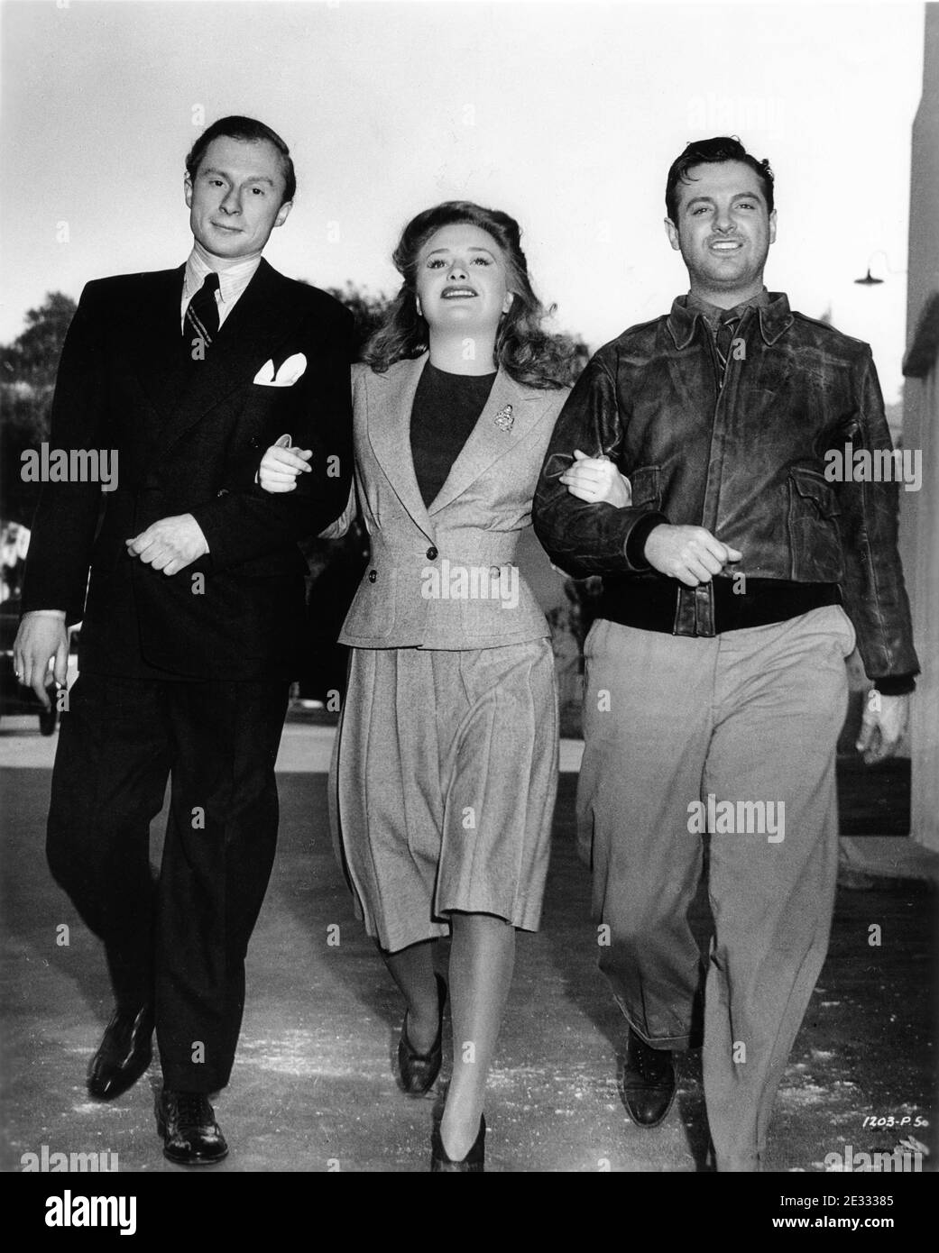 NORMAN LLOYD PRISCILLA LANE and ROBERT CUMMINGS candid on the Universal Studios Lot during filming of SABOTEUR 1942 director ALFRED HITCHCOCK original screenplay Peter Viertel Joan Harrison and Dorothy Parker Frank Lloyd Productions / Universal Pictures Stock Photo
