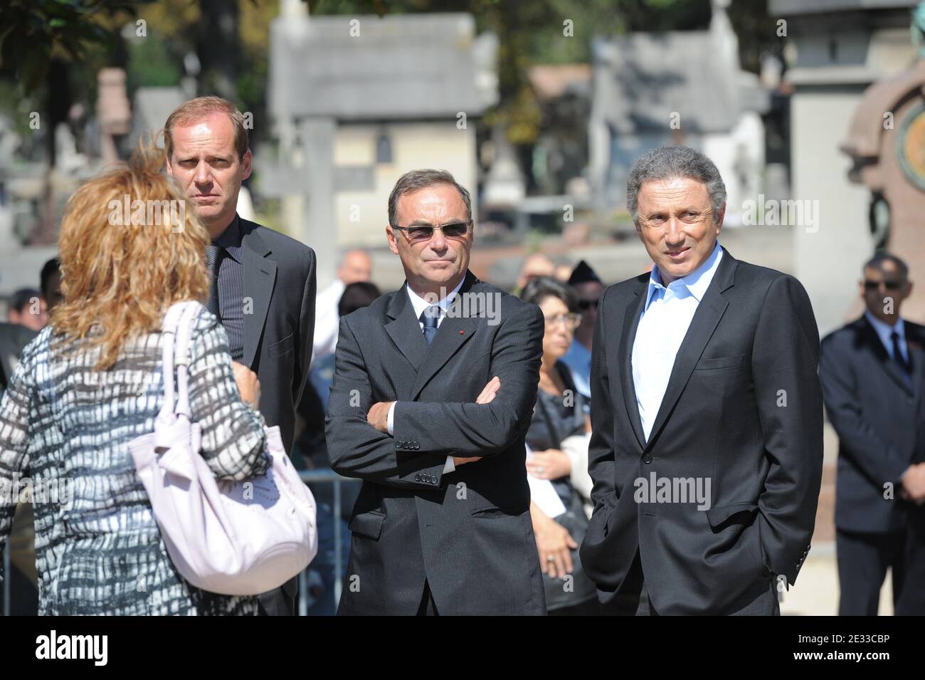 General director of the Tour de France Christian Prudhomme (L), five-times winner of the Tour de France Bernard Hinault (C) and TV host Michel Drucker (R) attend the funeral ceremony for French cycling champion Laurent Fignon at the Pere Lachaise crematorium in Paris, France on September 3, 2010. The former two-time Tour de France winner, aged 50, passed away in the Pitie-Salpetriere hospital in Paris on August 31, following a battle with cancer. Photo by Martin Bureau/Pool/ABACAPRESS.COM Stock Photo